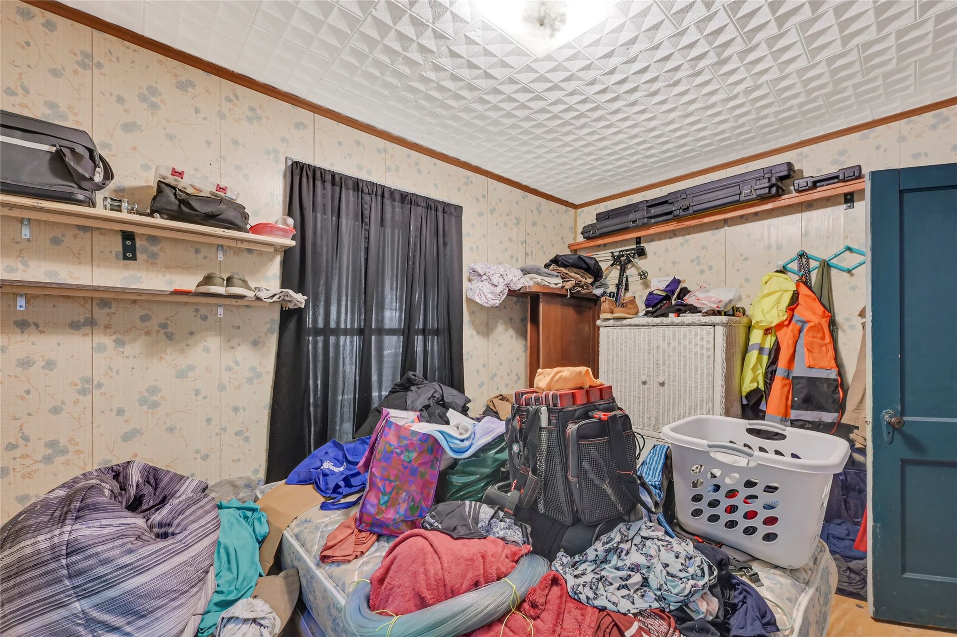 121 Patterson Road, Brazoria, TX 77422 Cozy room with potential for customization, featuring built-in shelving and ample natural light, ideal for storage or a personal retreat.