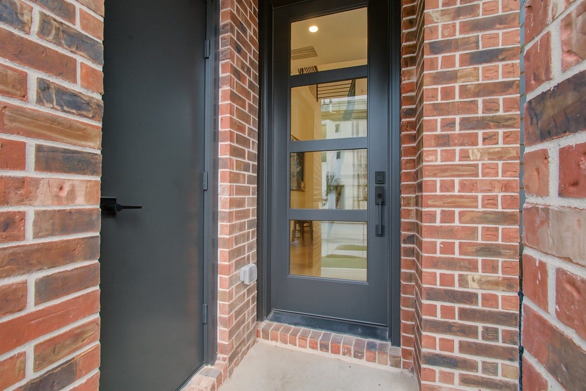 1113-1117 Ennis Street, Houston, TX 77003 front entry door with an amazon pacakge secured delivery closet