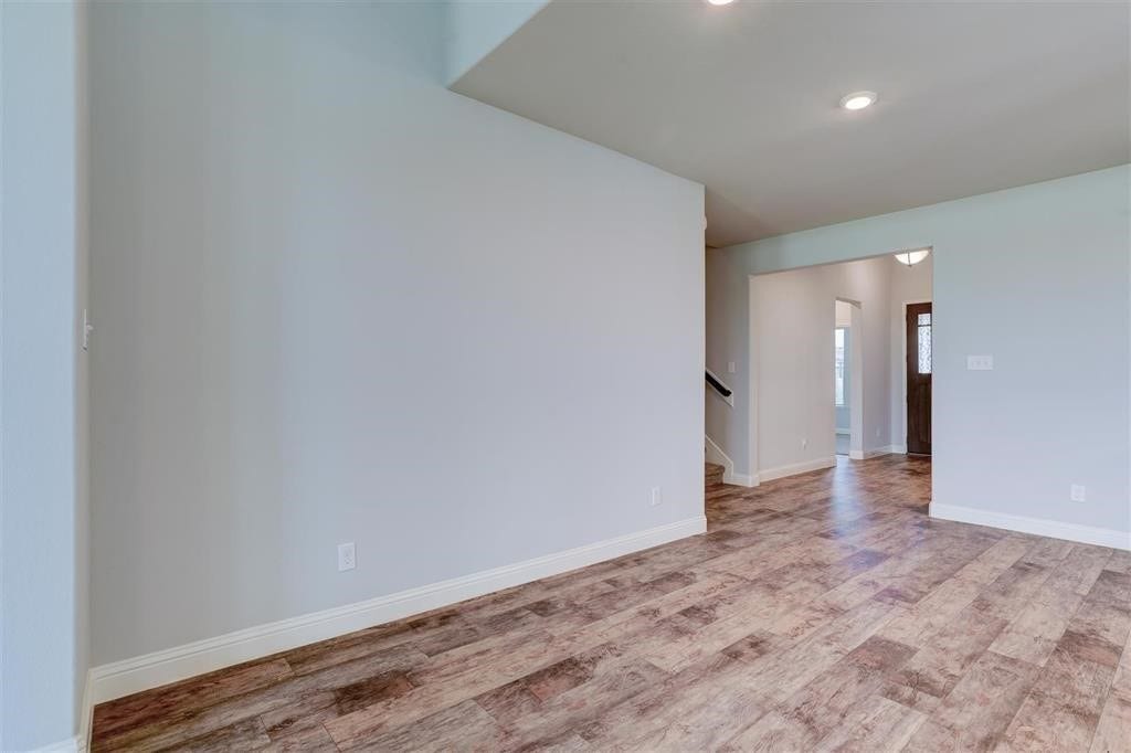 23715 Ruby Bramble Trail, Katy, TX 77493 Spacious and inviting entryway featuring elegant wood-style flooring and abundant natural light, offering a warm welcome into the home.