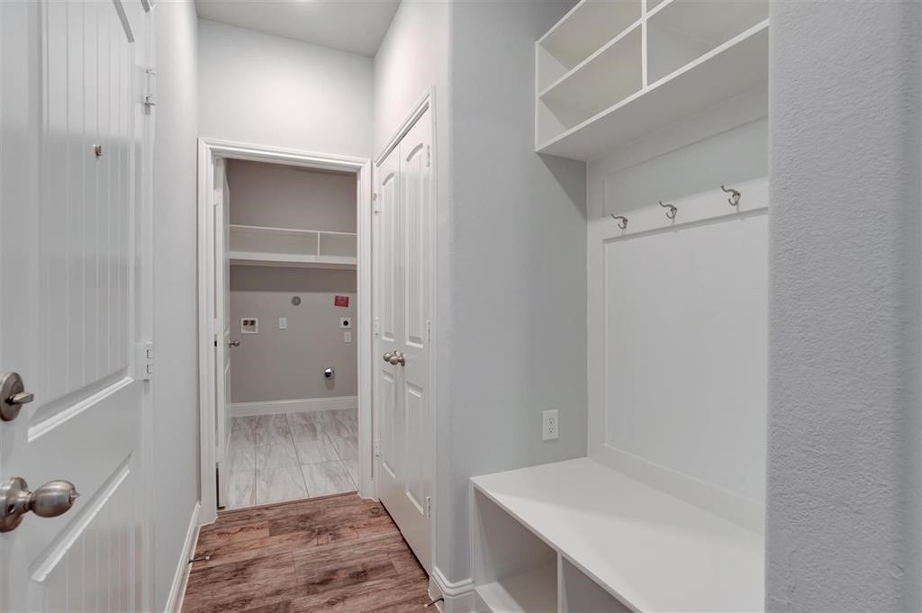 23715 Ruby Bramble Trail, Katy, TX 77493 Spacious utility area with built-in storage, hooks, and a convenient laundry setup, perfect for organization and functionality.