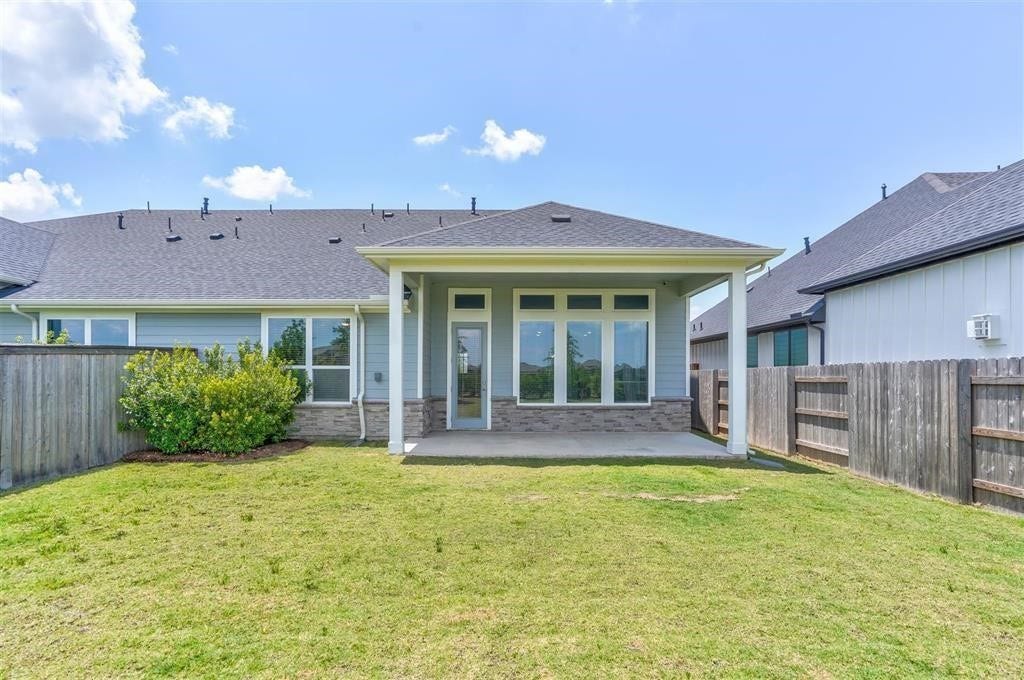 23715 Ruby Bramble Trail, Katy, TX 77493 Charming covered patio overlooking a spacious, fenced backyard, perfect for outdoor relaxation and entertaining.