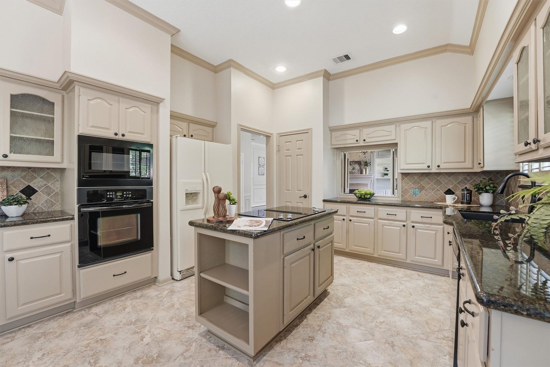 3203 Hickory Brook Lane, Houston, TX 77345 Kitchen view highlighting the island cooktop, built-in oven and cabinetry.