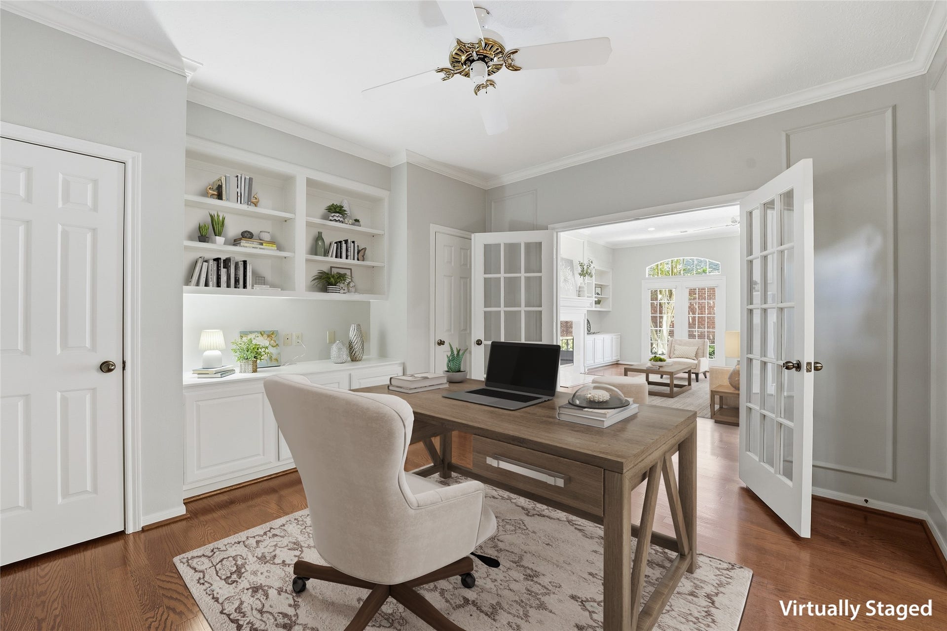 3203 Hickory Brook Lane, Houston, TX 77345 Third bedroom shown as a home office with built-in shelving, two closets, and access to the adjoining bonus room. Virtually staged.
