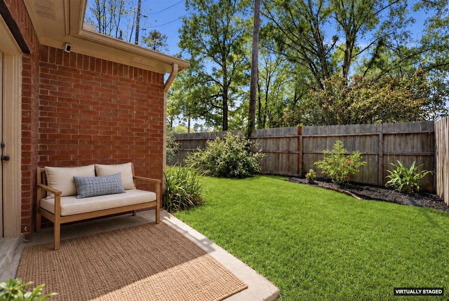 3203 Hickory Brook Lane, Houston, TX 77345 Additional backyard view showing the fenced lawn beside the patio. Virtually Staged
