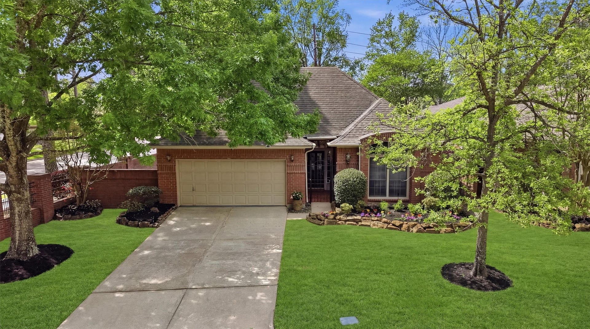 3203 Hickory Brook Lane, Houston, TX 77345 Wider front view highlighting the driveway, two-car garage and mature landscaping.