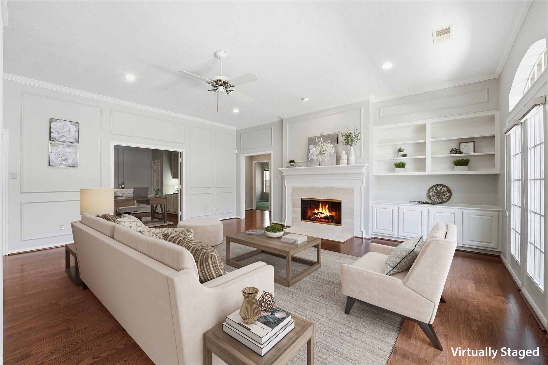 3203 Hickory Brook Lane, Houston, TX 77345 Spacious family room with a gas-log fireplace, custom built-ins and an open connection to the kitchen. Virtually staged.
