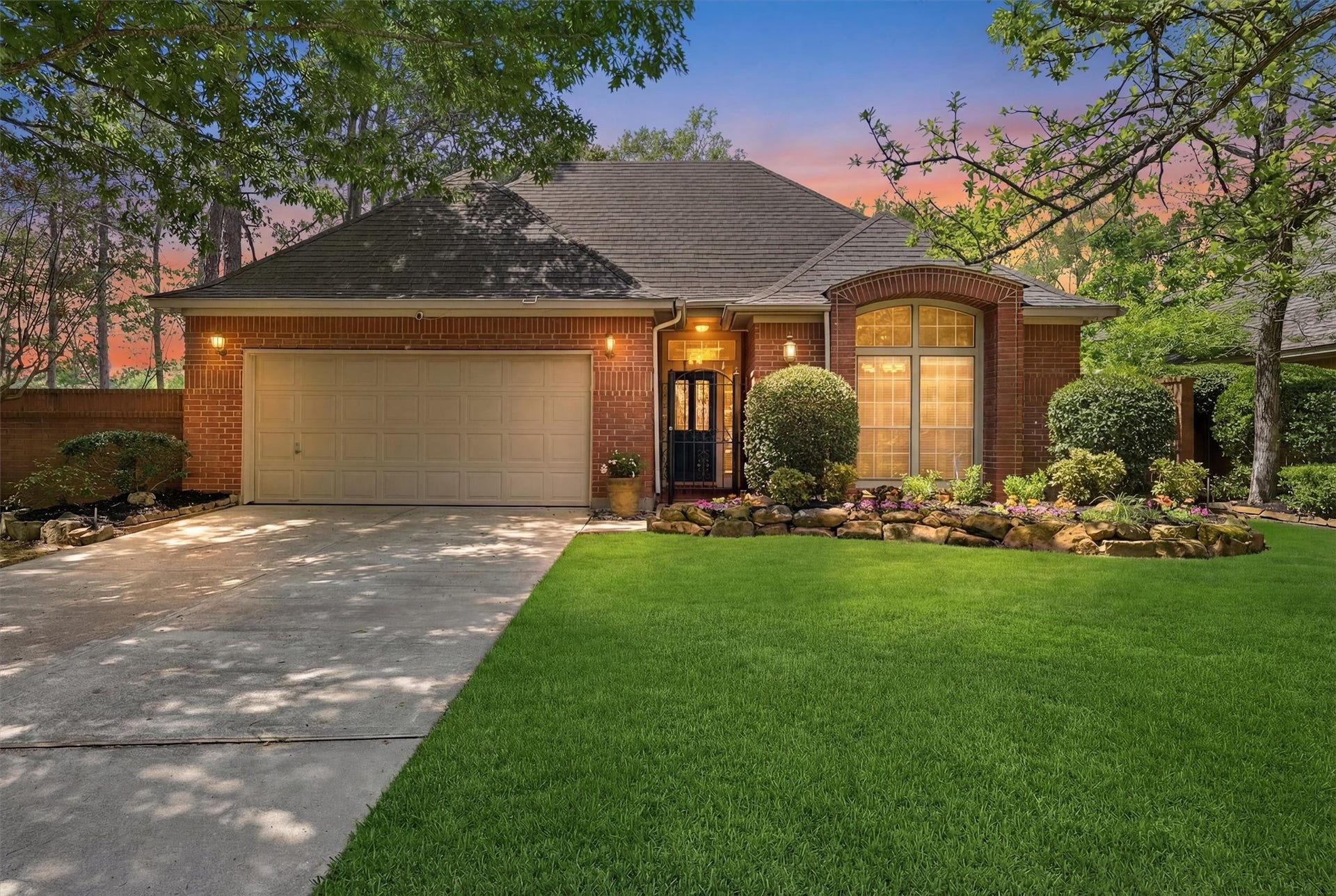 3203 Hickory Brook Lane, Houston, TX 77345 Evening view of the homes brick exterior and illuminated entry.