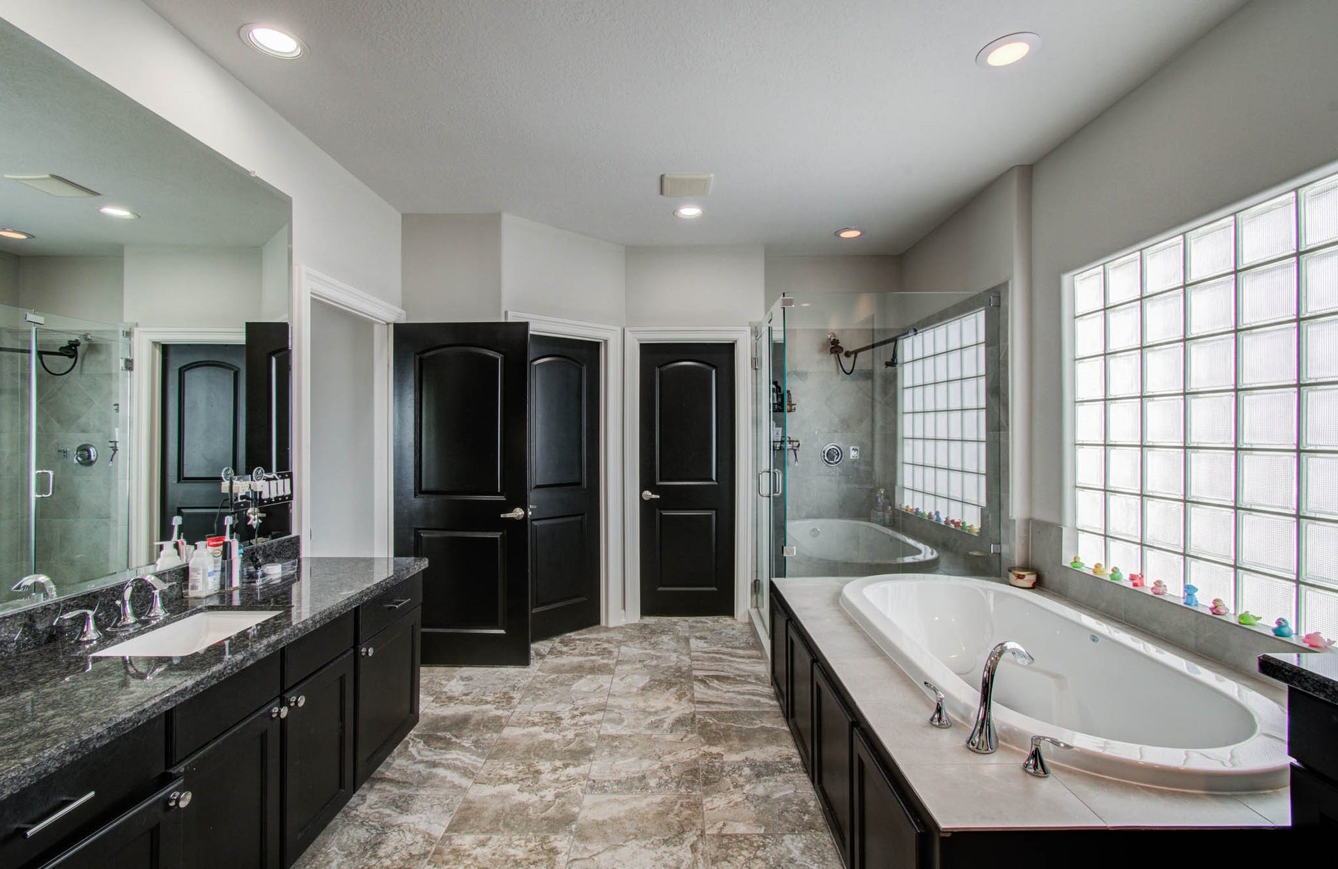 11123 Olympia Drive, Houston, TX 77042 Primary bathroom with 2 walk in closets, separate tub and shower.