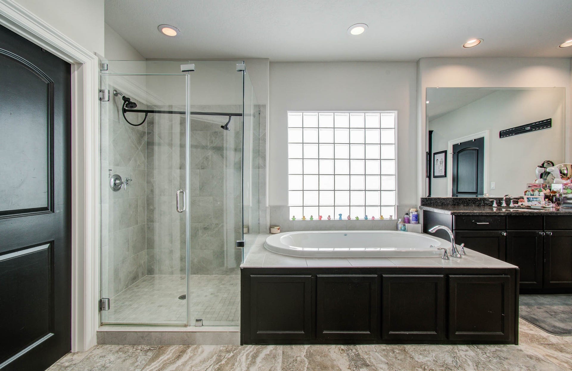 11123 Olympia Drive, Houston, TX 77042 Primary bathroom with 2 walk in closets, separate tub and shower.