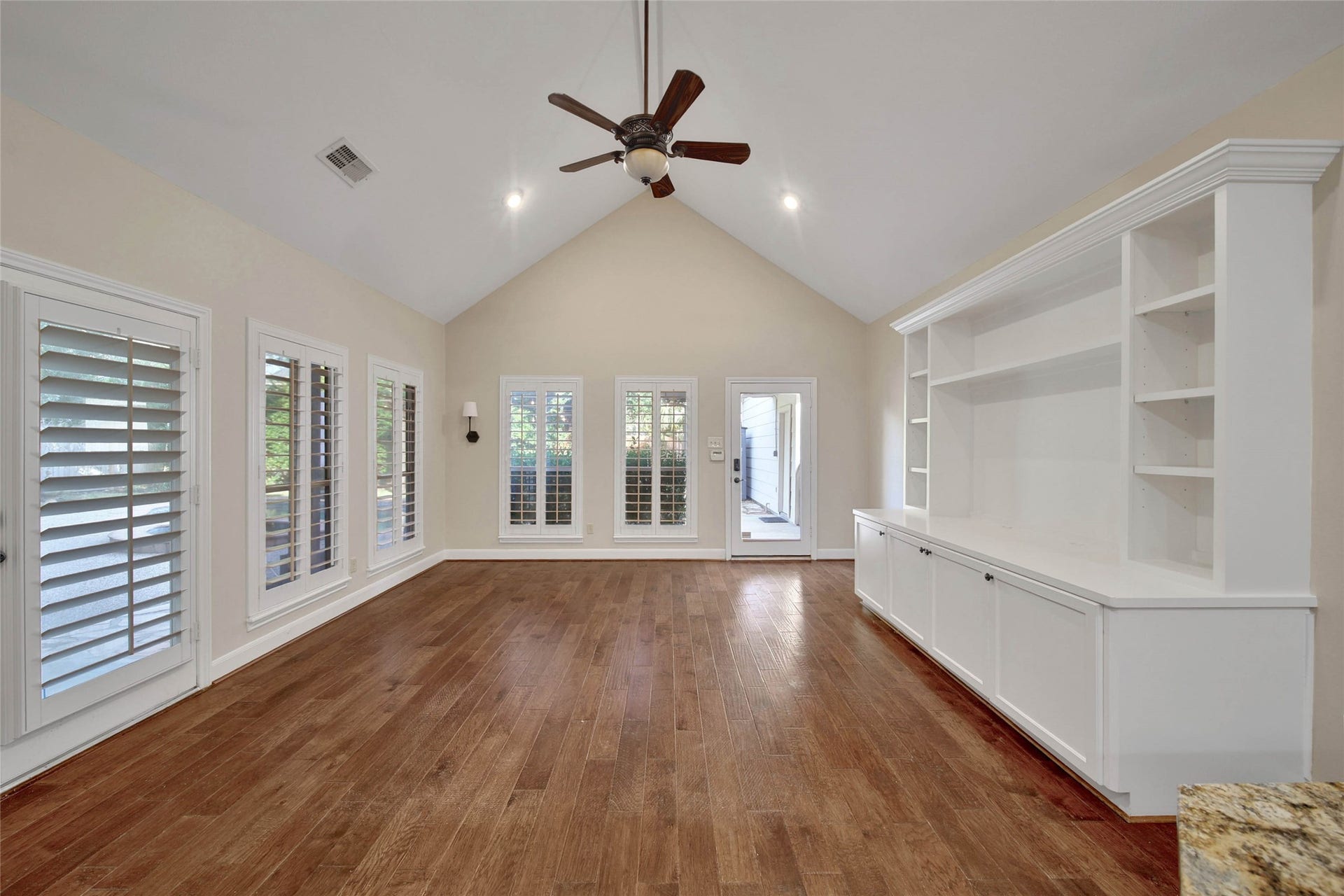 5814 Woodland Creek Drive, Kingwood, TX 77345 The den is located off the kitchen and has a large built-in for your entertaining needs. bright windows of the pool, patio and backyard surround this room. Vaulted ceiling adds to the spacious feel.