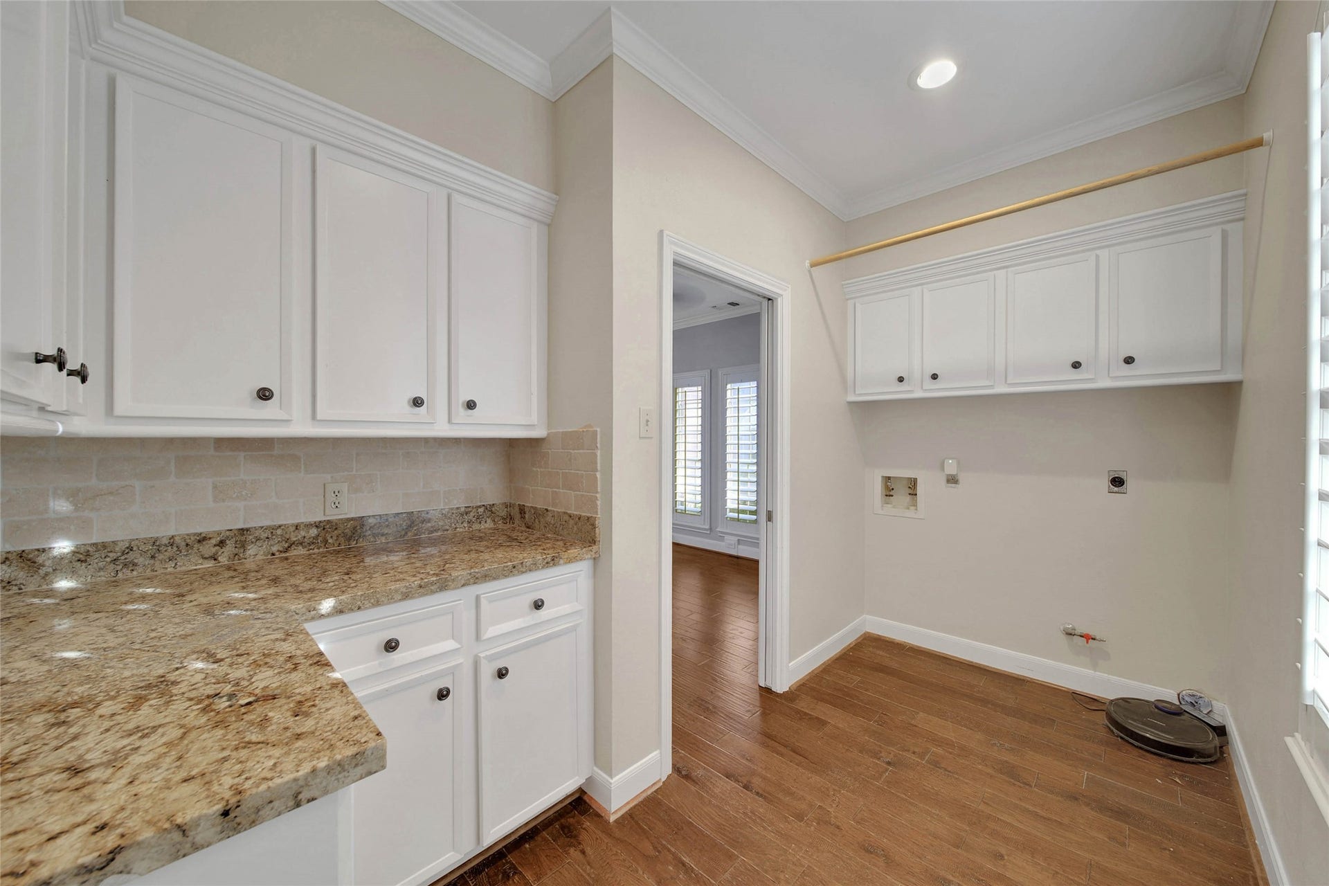 5814 Woodland Creek Drive, Kingwood, TX 77345 Rare Butlers Pantry / laundry / Utility room is spacious. Featuring a granite worktop for food prep, or entertaining prep, lots of cabinetry for storage of seasonal items and room for a second fridge or upright freezer too! Bright sunny window faces the street and has plantation shutters.
