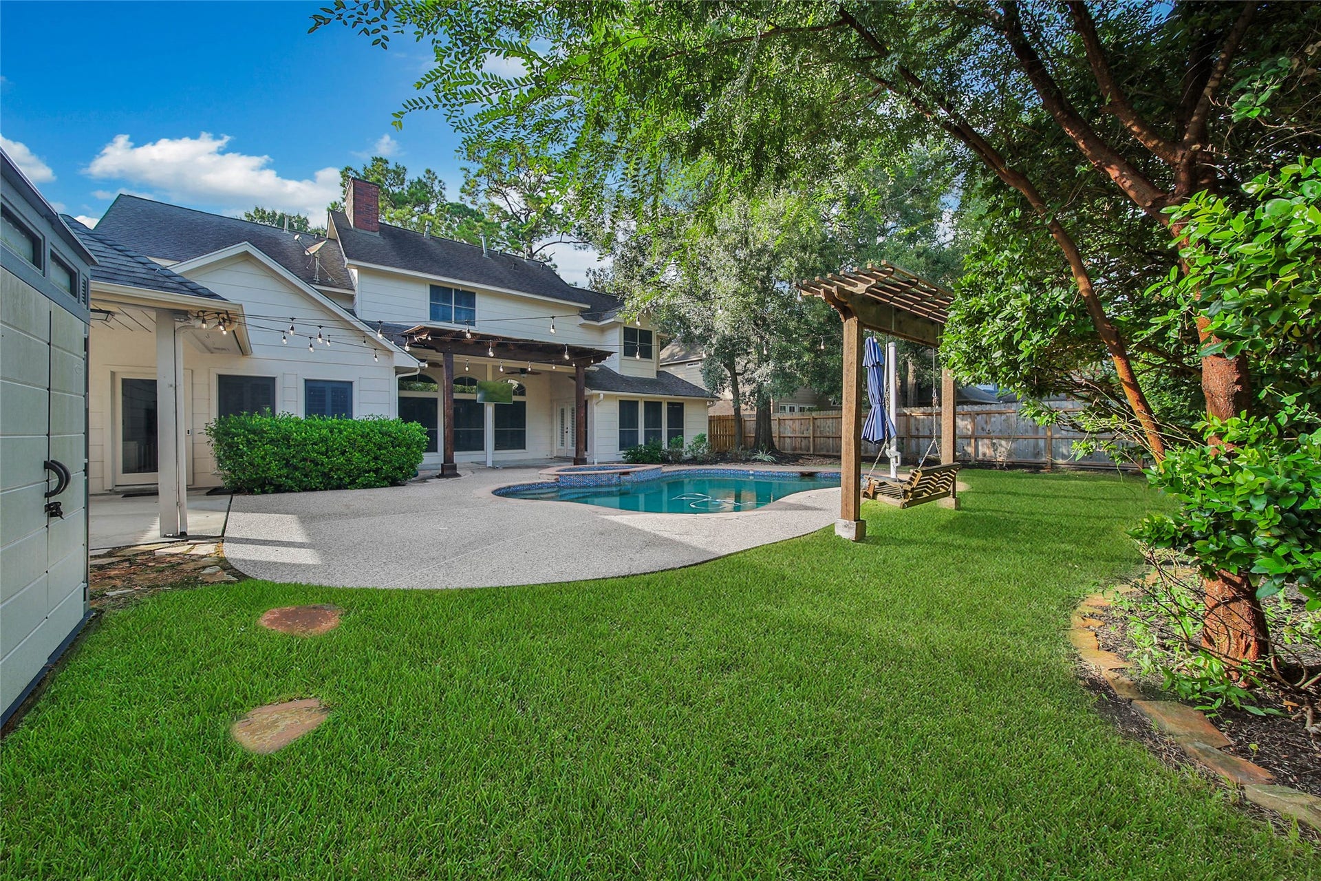 5814 Woodland Creek Drive, Kingwood, TX 77345 This private backyard offers something for everyone whether its cooling off in the pool or playing in the spacious backyard.