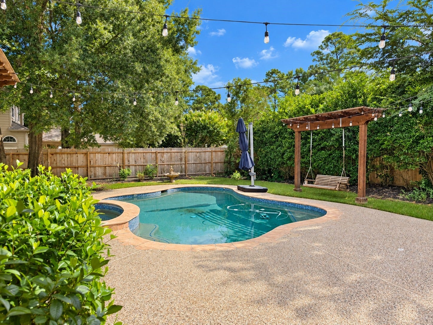 5814 Woodland Creek Drive, Kingwood, TX 77345 Private landscaping and extended pool decking for you to relax and cool off in the pool.