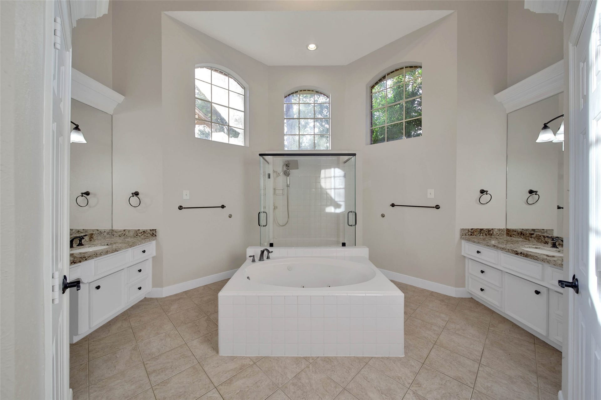 5814 Woodland Creek Drive, Kingwood, TX 77345 Separate whirlpool tub huge oversize shower with two doors, high ceilings and bright windows up high, separate vanities and lots of storage make this a fabulous bathroom.