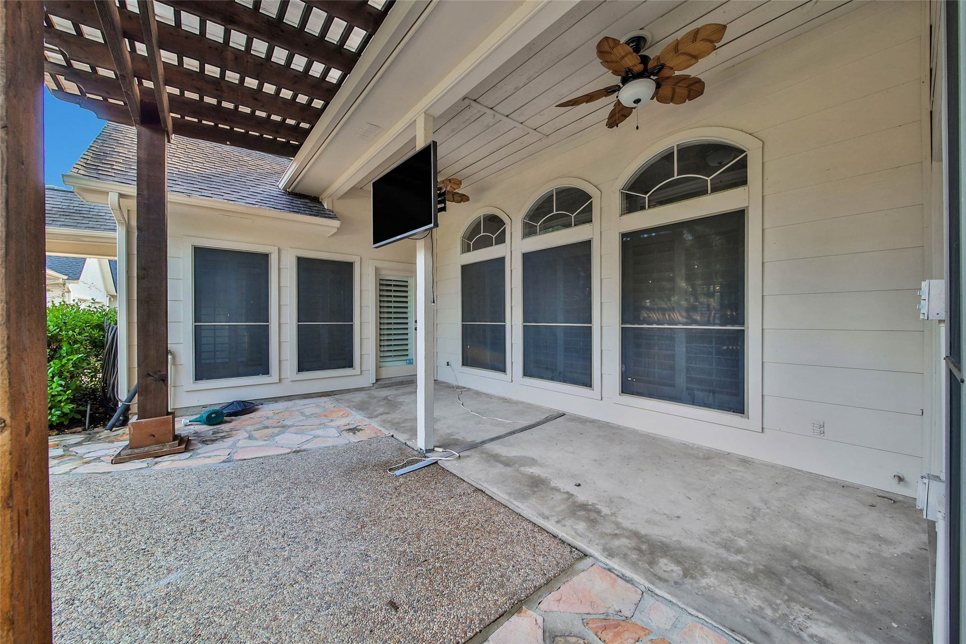 5814 Woodland Creek Drive, Kingwood, TX 77345 The covered patio and pergola is a great place to relax while you enjoy the pool and outdoors.