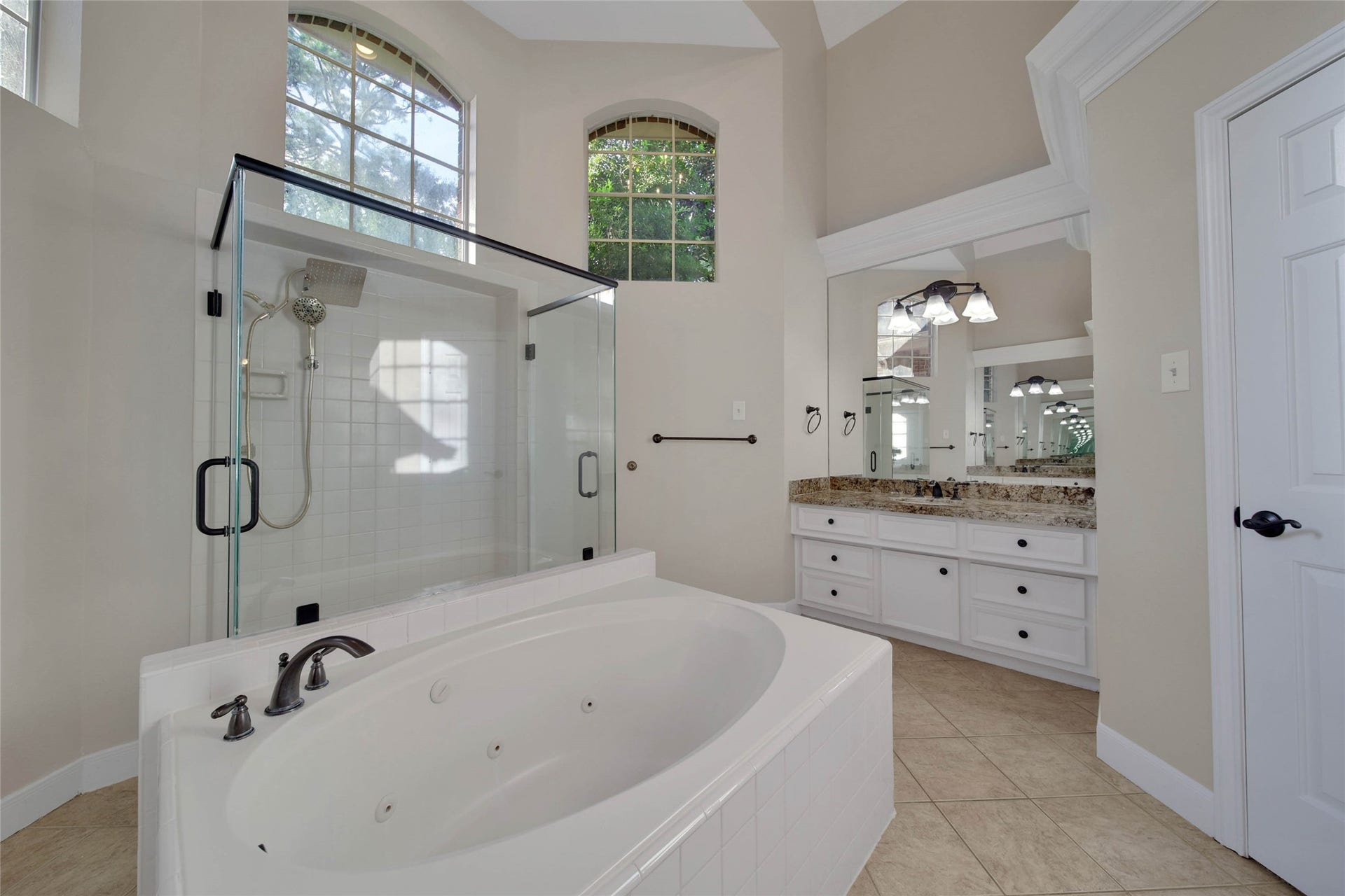 5814 Woodland Creek Drive, Kingwood, TX 77345 Separate whirlpool tub huge oversize shower with two doors, high ceilings and bright windows up high, separate vanities and lots of storage make this a fabulous bathroom.