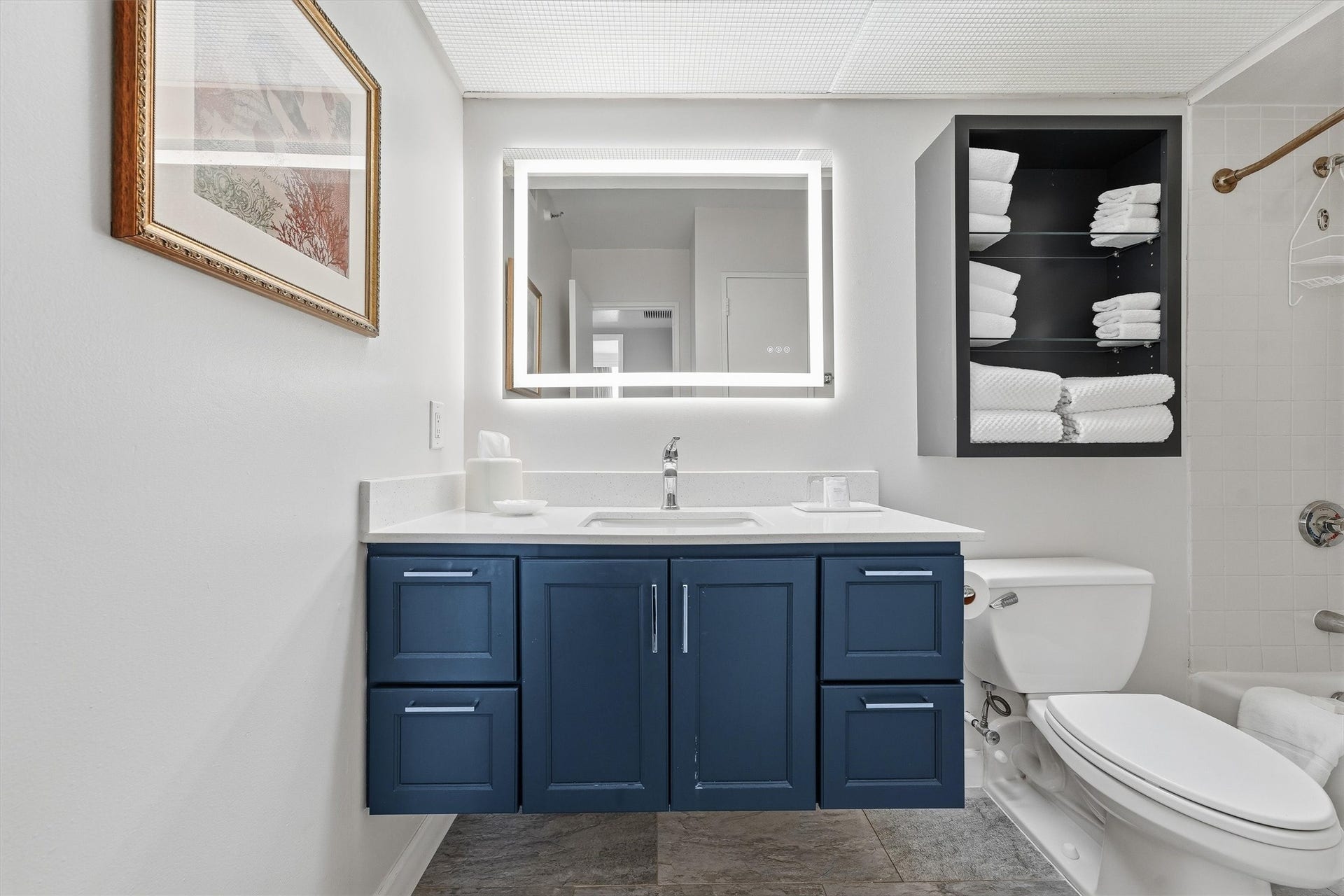 5220 Seawall Boulevard, #1233D, Galveston, TX 77551 A colorful vanity adds a stylish contrast, while drawers and open shelving provide convenient bathroom storage.