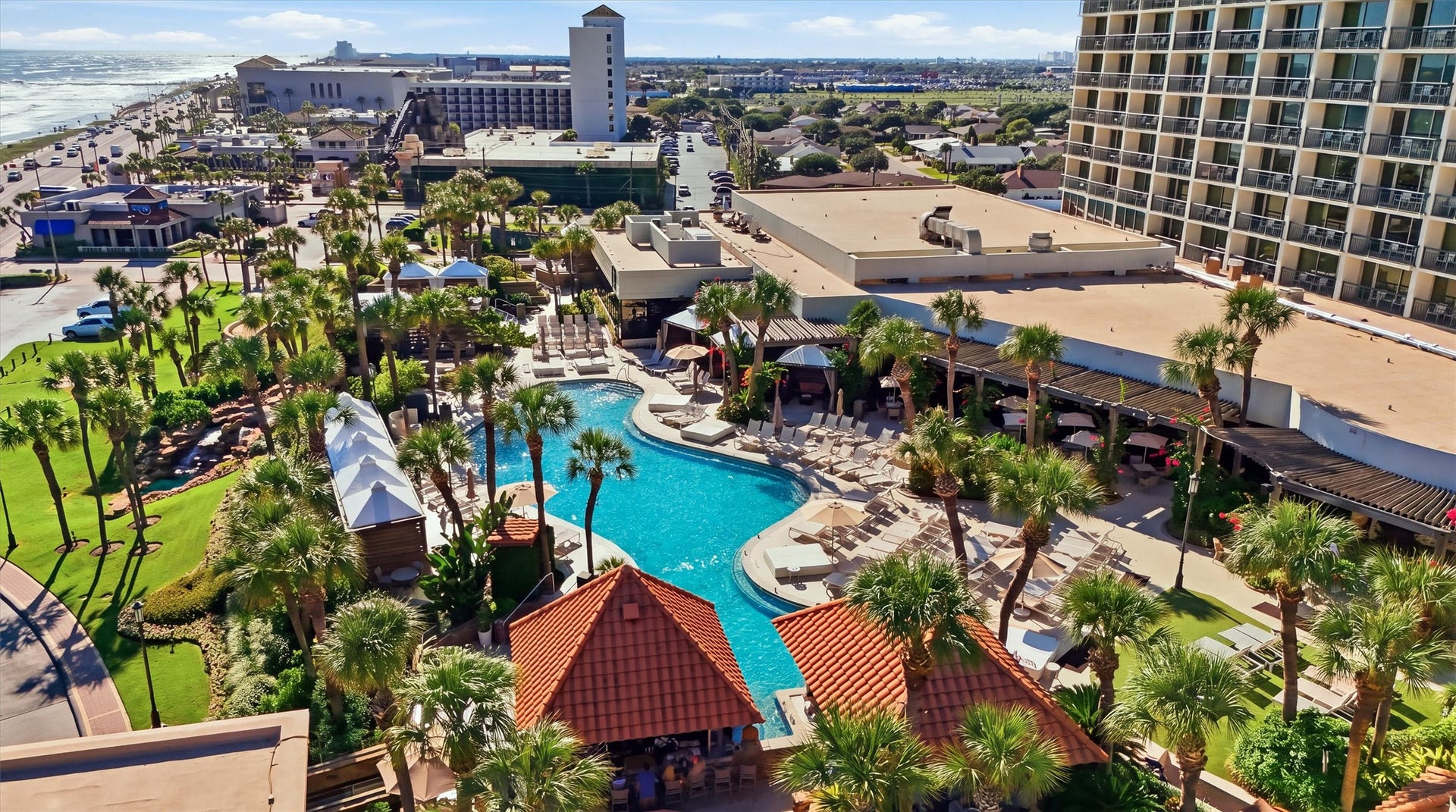 5220 Seawall Boulevard, #1233D, Galveston, TX 77551 Enjoy a tropical poolside setting surrounded by palm trees, lush landscaping, and inviting lounge areas.