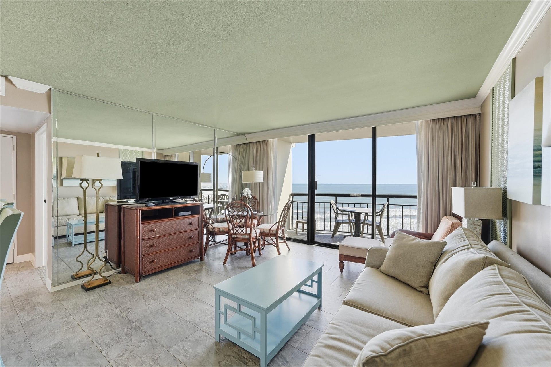 5220 Seawall Boulevard, #1233D, Galveston, TX 77551 Natural light fills the living area, where sliding glass doors frame beautiful Gulf views.
