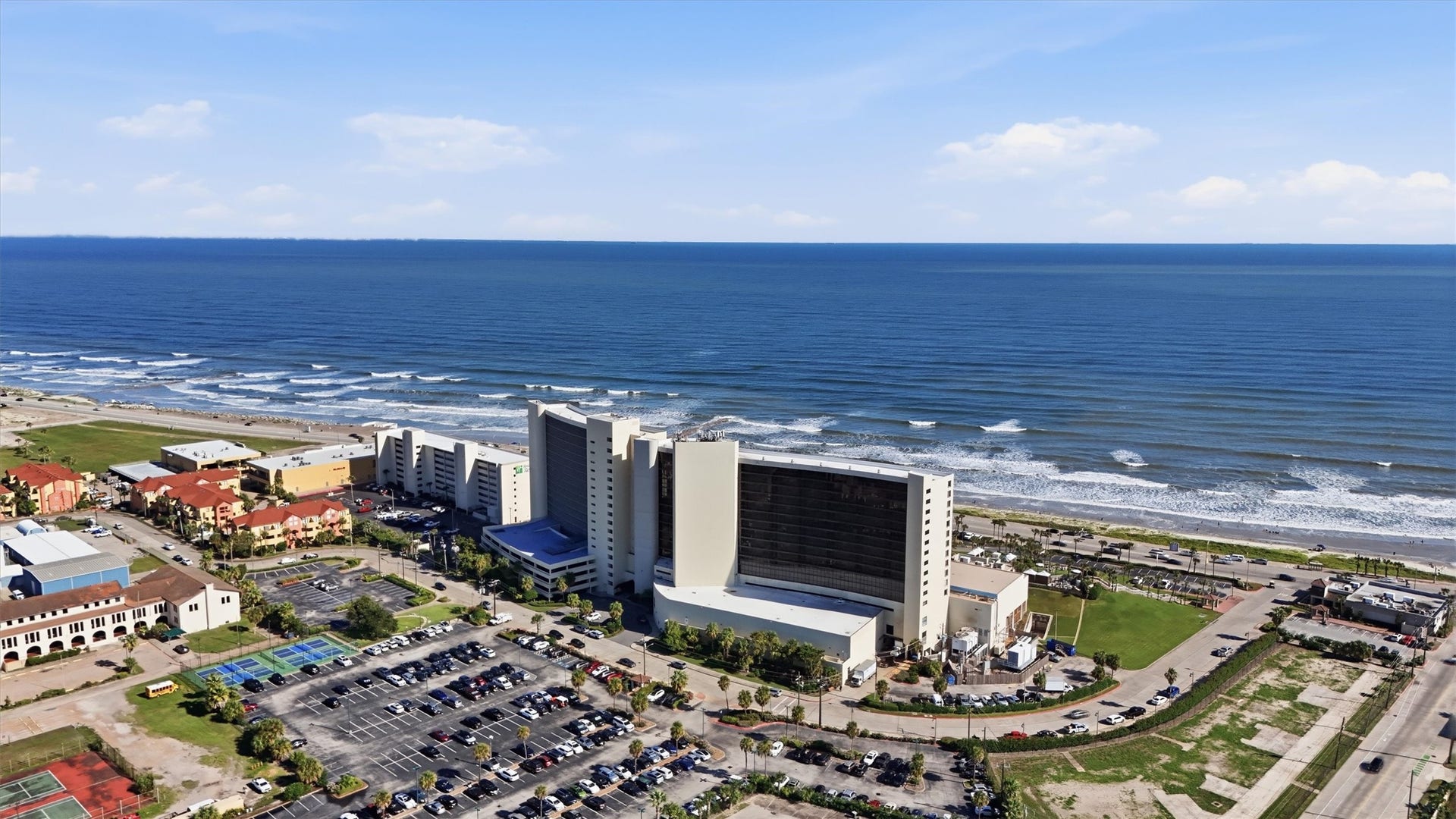 5220 Seawall Boulevard, #1233D, Galveston, TX 77551 An expansive aerial view captures the San Luis, surrounding grounds, and the beach just across the Seawall.