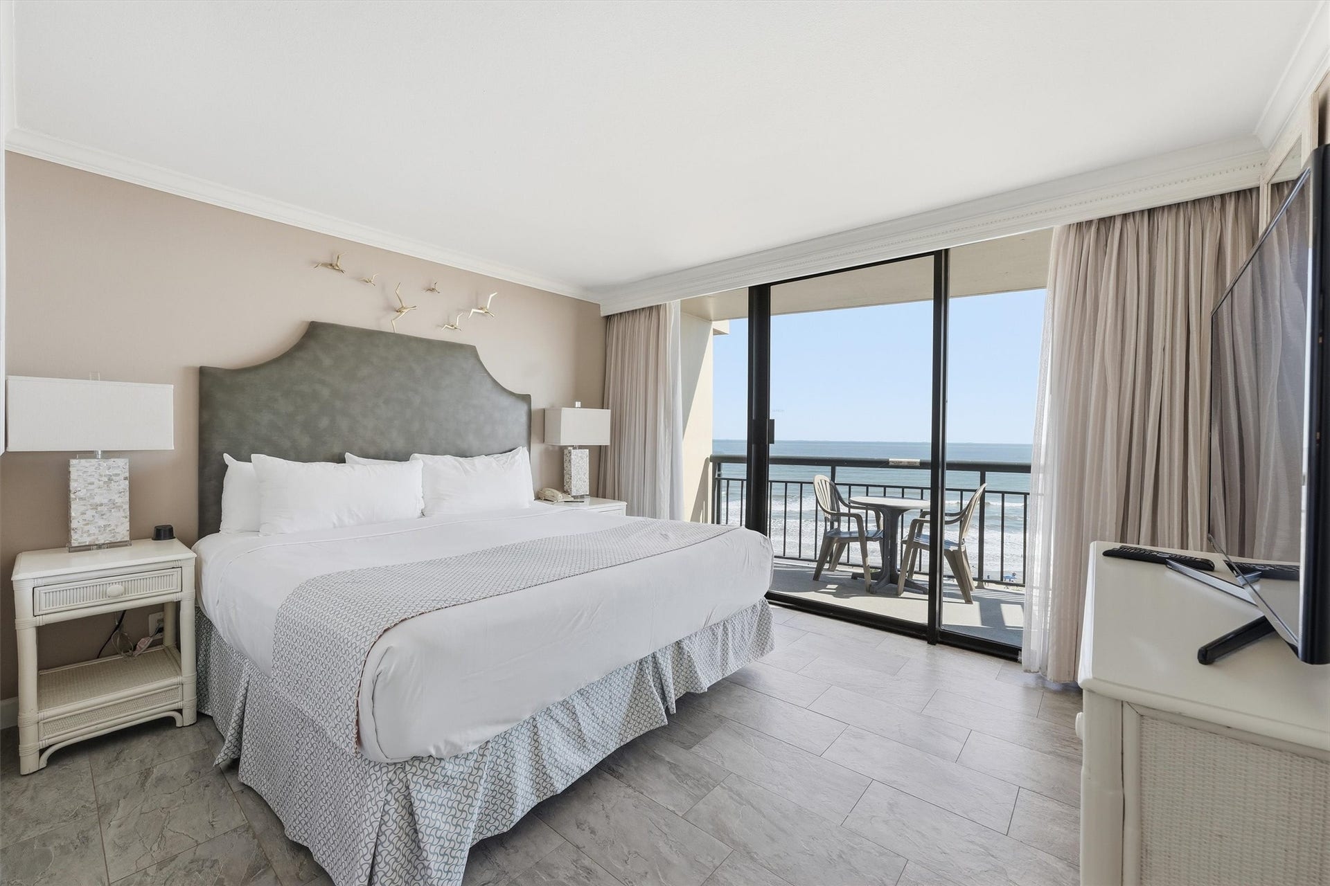 5220 Seawall Boulevard, #1233D, Galveston, TX 77551 Rest and recharge in a light-filled bedroom with Gulf views and direct access to a balcony.