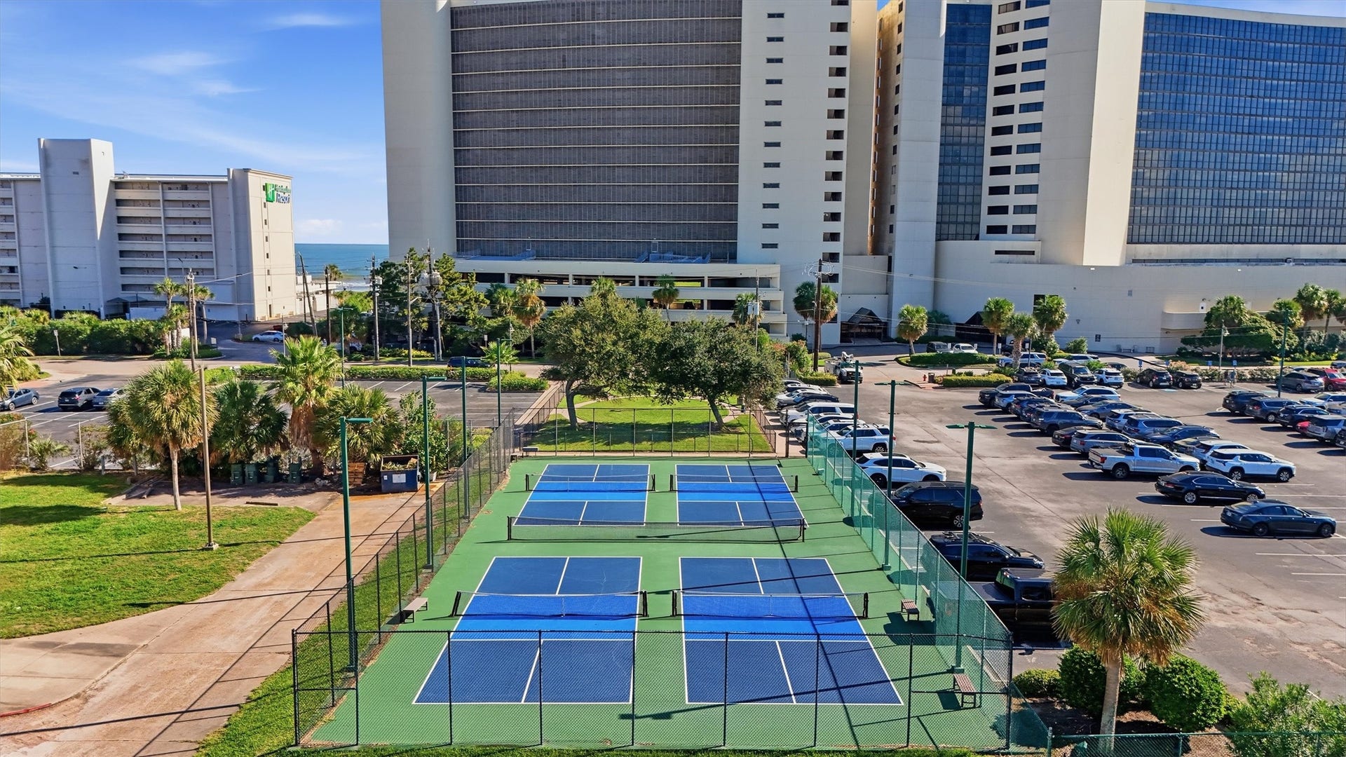 5220 Seawall Boulevard, #1233D, Galveston, TX 77551 On-site tennis courts offer a scenic setting for a friendly match beneath the coastal sky.