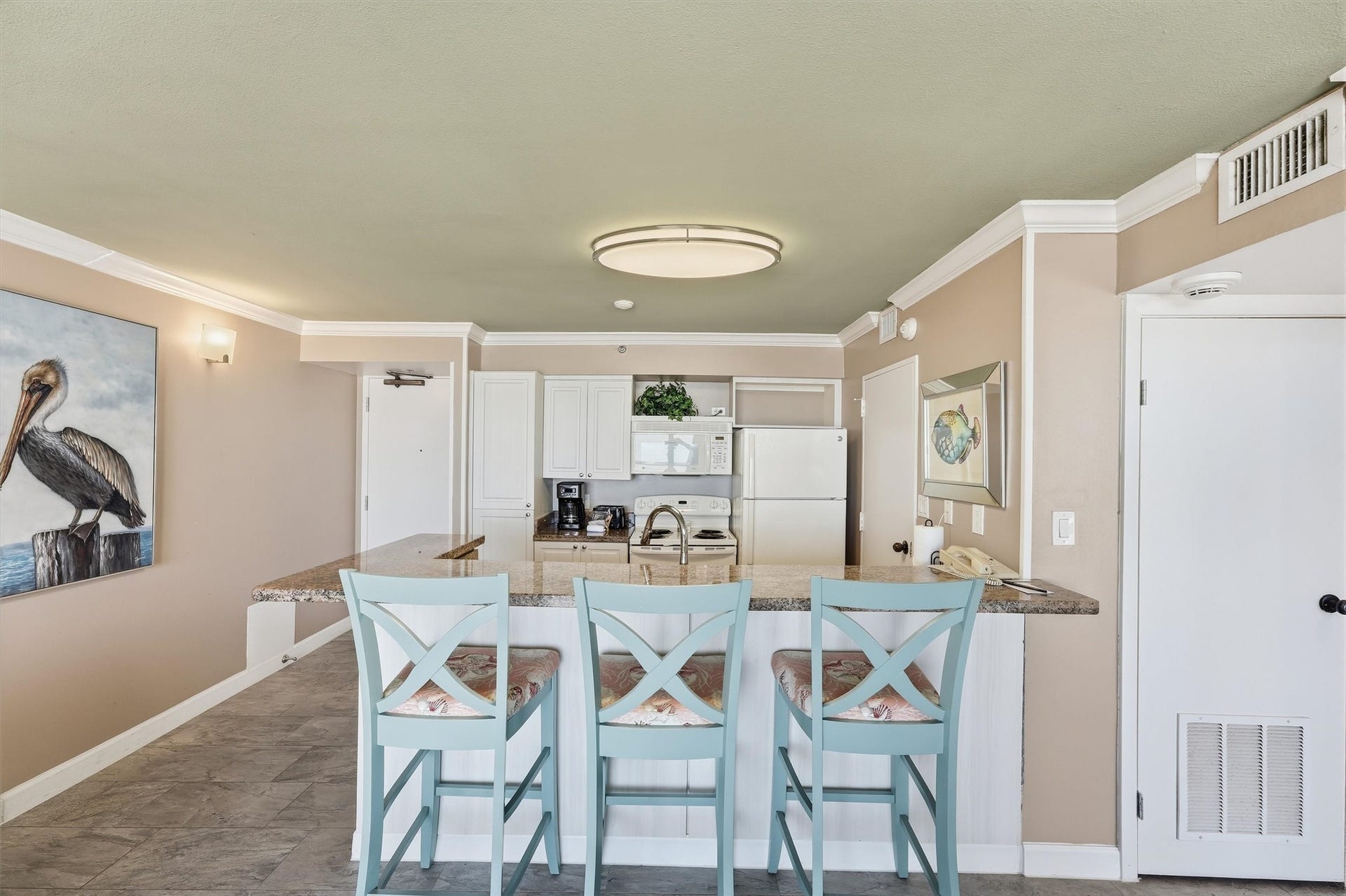 5220 Seawall Boulevard, #1233D, Galveston, TX 77551 The breakfast bar connects the kitchen and living area, keeping everyone part of the conversation.