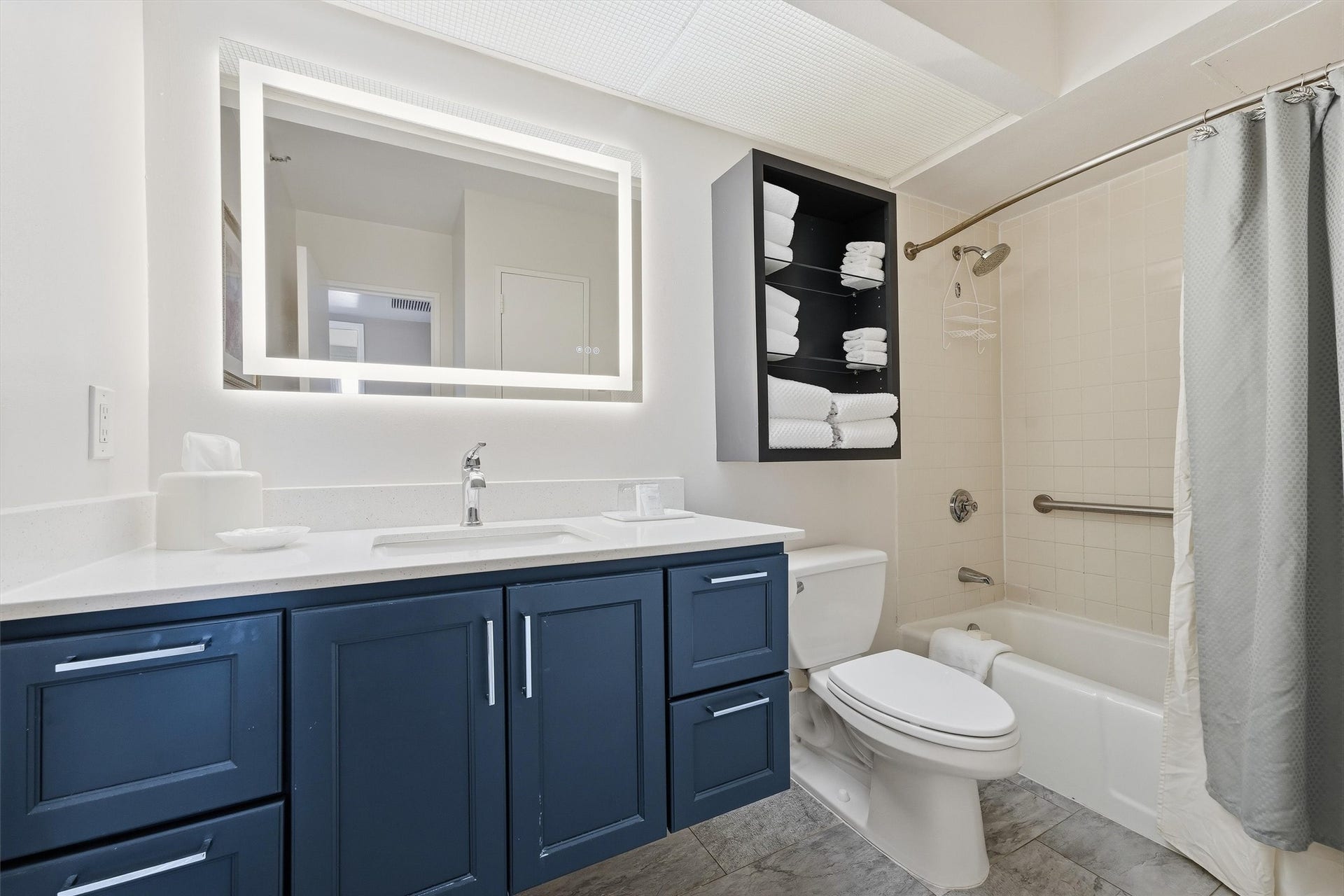 5220 Seawall Boulevard, #1233D, Galveston, TX 77551 The bathroom features a spacious vanity, illuminated mirror, and a versatile tub/shower combination.