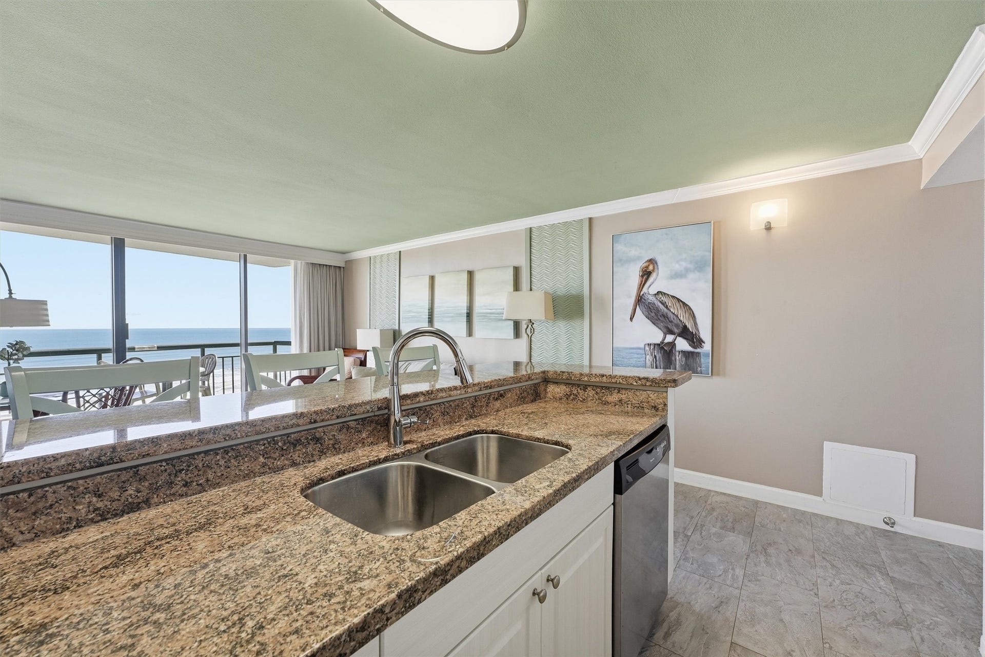 5220 Seawall Boulevard, #1233D, Galveston, TX 77551 Enjoy views of the water from the kitchen, featuring a double-basin sink and an expansive countertop.