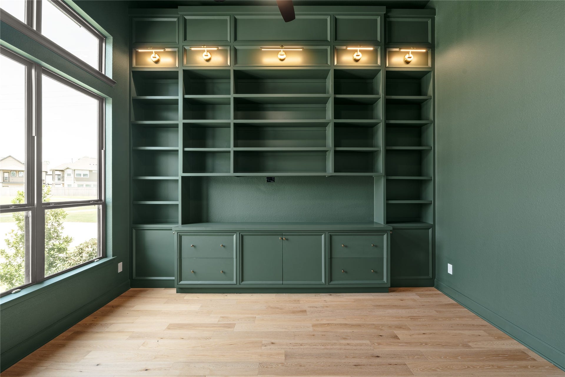9607 Maple Wood Drive, Missouri City, TX 77459 Elegant study with custom built-in shelving, color drenched room, and large windows for natural light, offering a perfect balance of sophistication and functionality.