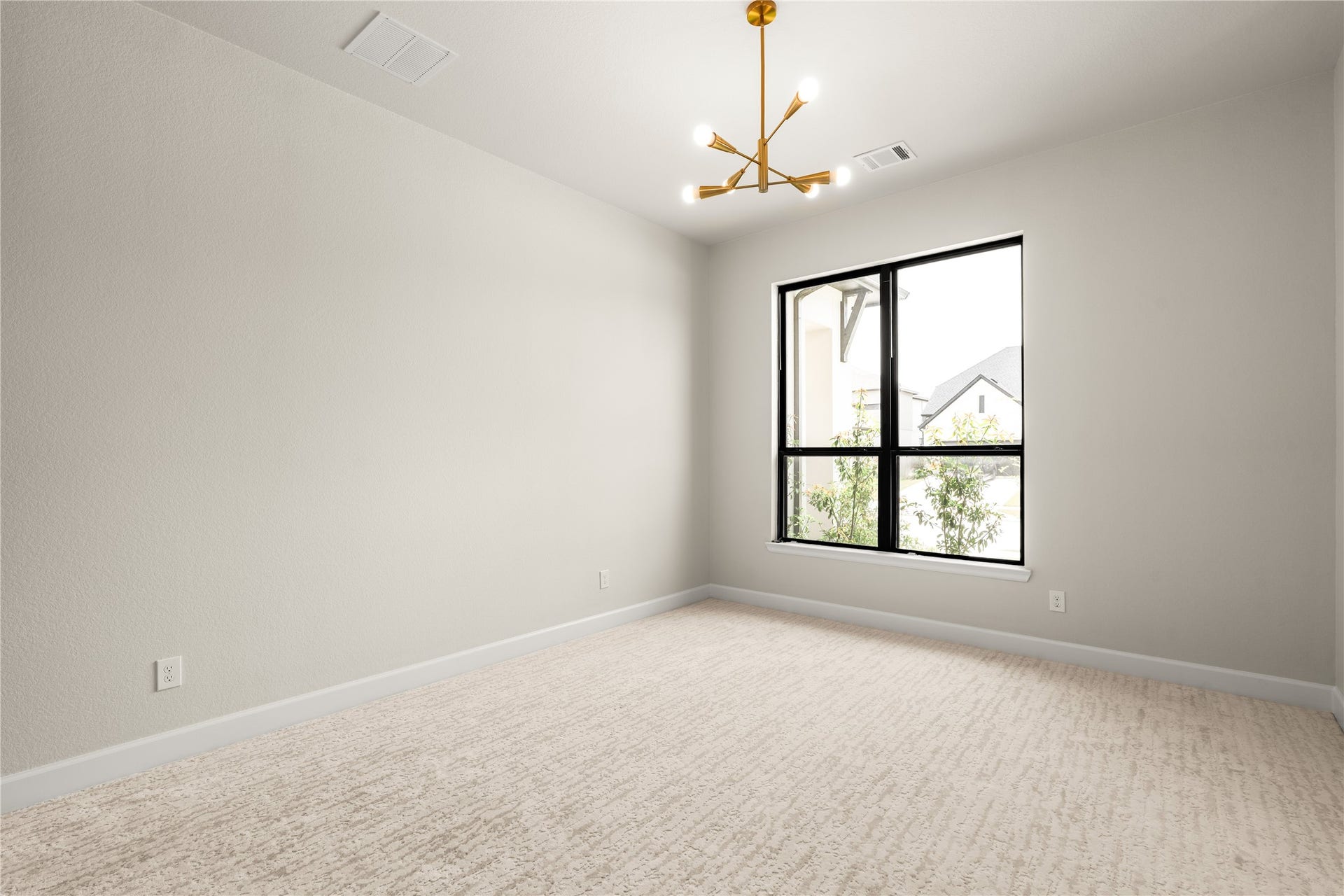 9607 Maple Wood Drive, Missouri City, TX 77459 Bright and airy secondary bedroom featuring a modern light fixture and a large window that invites natural light, complemented by soft carpet flooring and neutral walls.