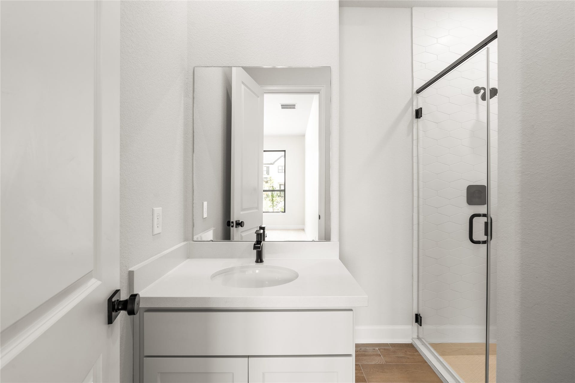 9607 Maple Wood Drive, Missouri City, TX 77459 Modern bathroom featuring a sleek vanity, elegant fixtures, and a spacious glass-enclosed shower.