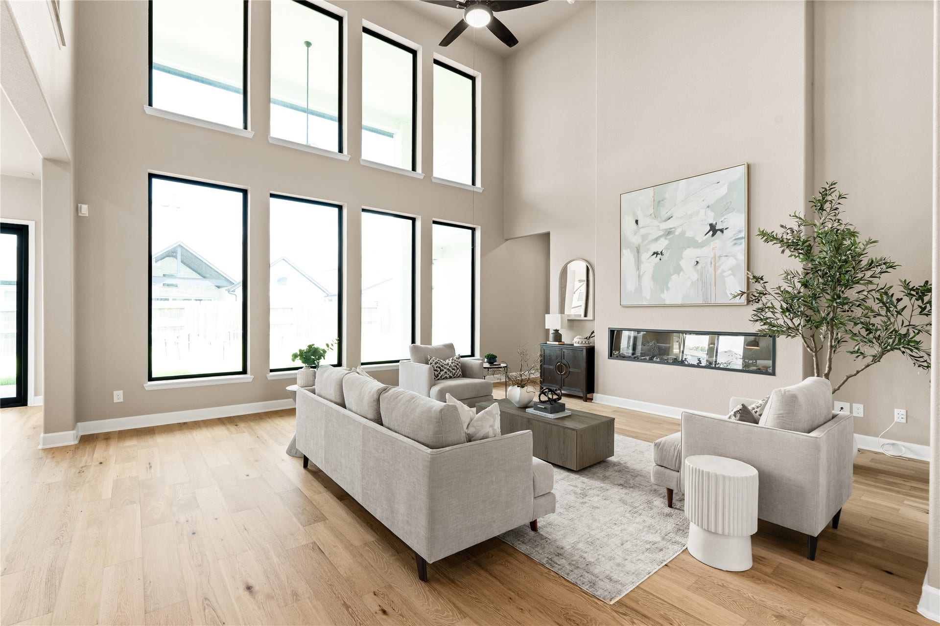 9607 Maple Wood Drive, Missouri City, TX 77459 Stunning living room with soaring ceilings, expansive windows for natural light, and a modern fireplace accentuating the open space. *Virtually Staged*