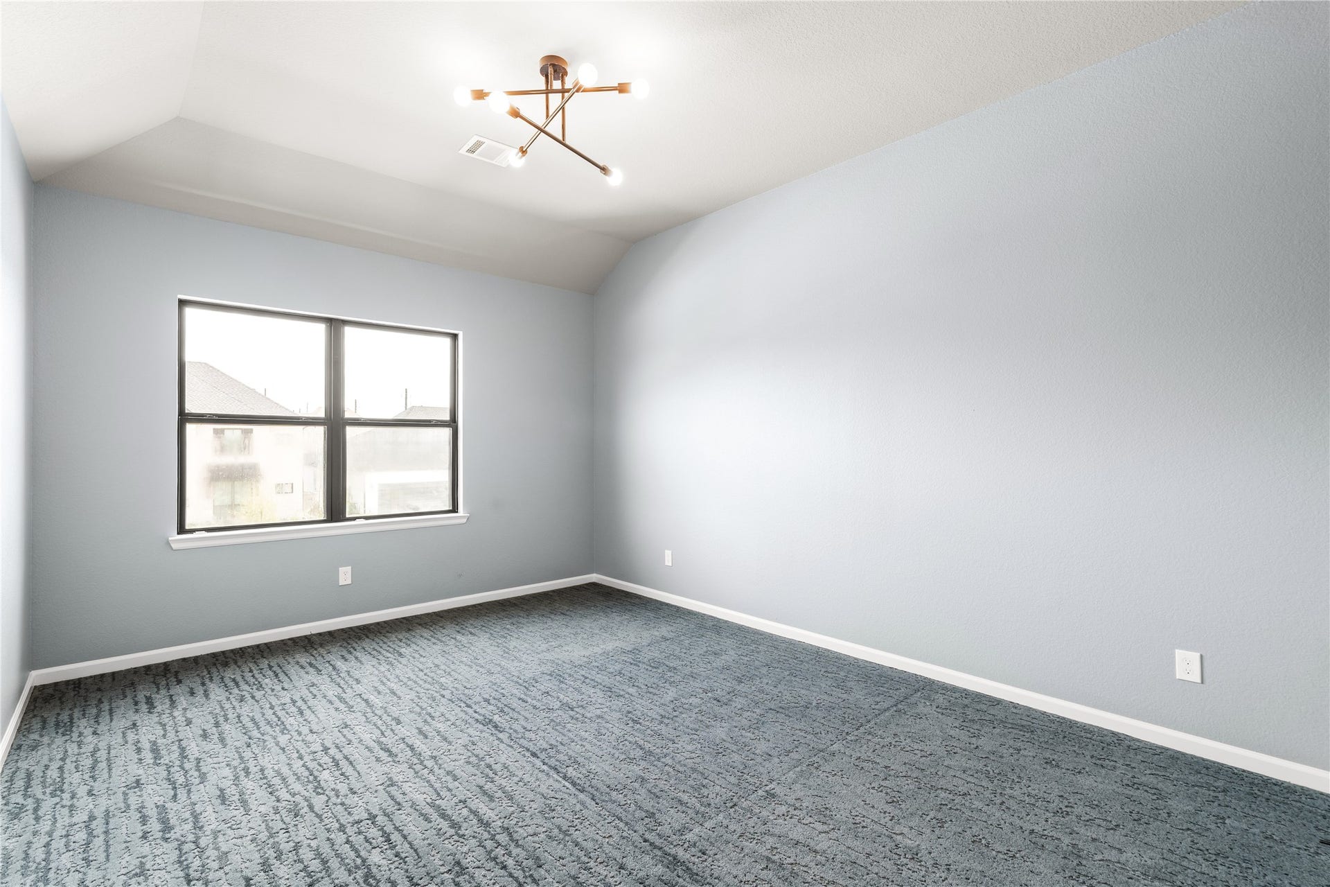 9607 Maple Wood Drive, Missouri City, TX 77459 Spacious secondary bedroom with plush carpeting, enhanced by a modern light fixture and a large window providing ample natural light.