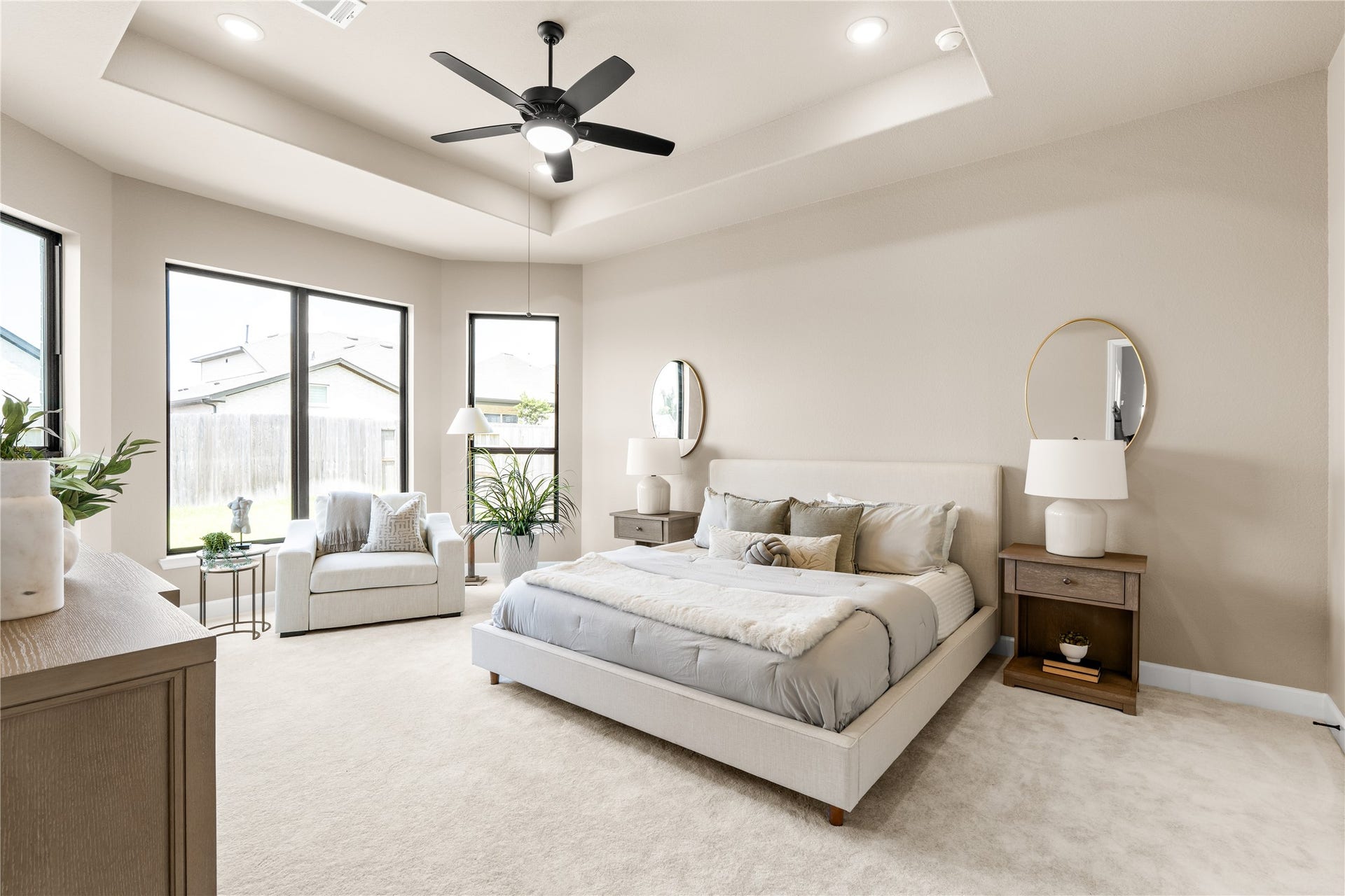 9607 Maple Wood Drive, Missouri City, TX 77459 Welcome home to your sunlit primary bedroom featuring a tray ceiling, modern ceiling fan, and large windows overlooking the backyard. *Virtually Staged*