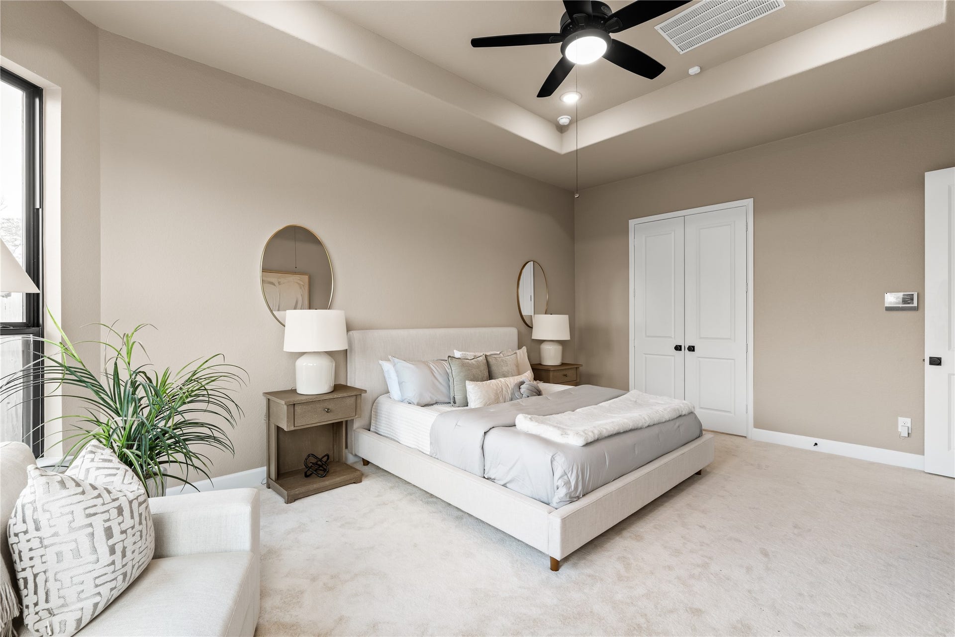 9607 Maple Wood Drive, Missouri City, TX 77459 Generous primary bedroom with neutral tones, large windows for natural light, and an architecturally interesting ceiling. *Virtually Staged*
