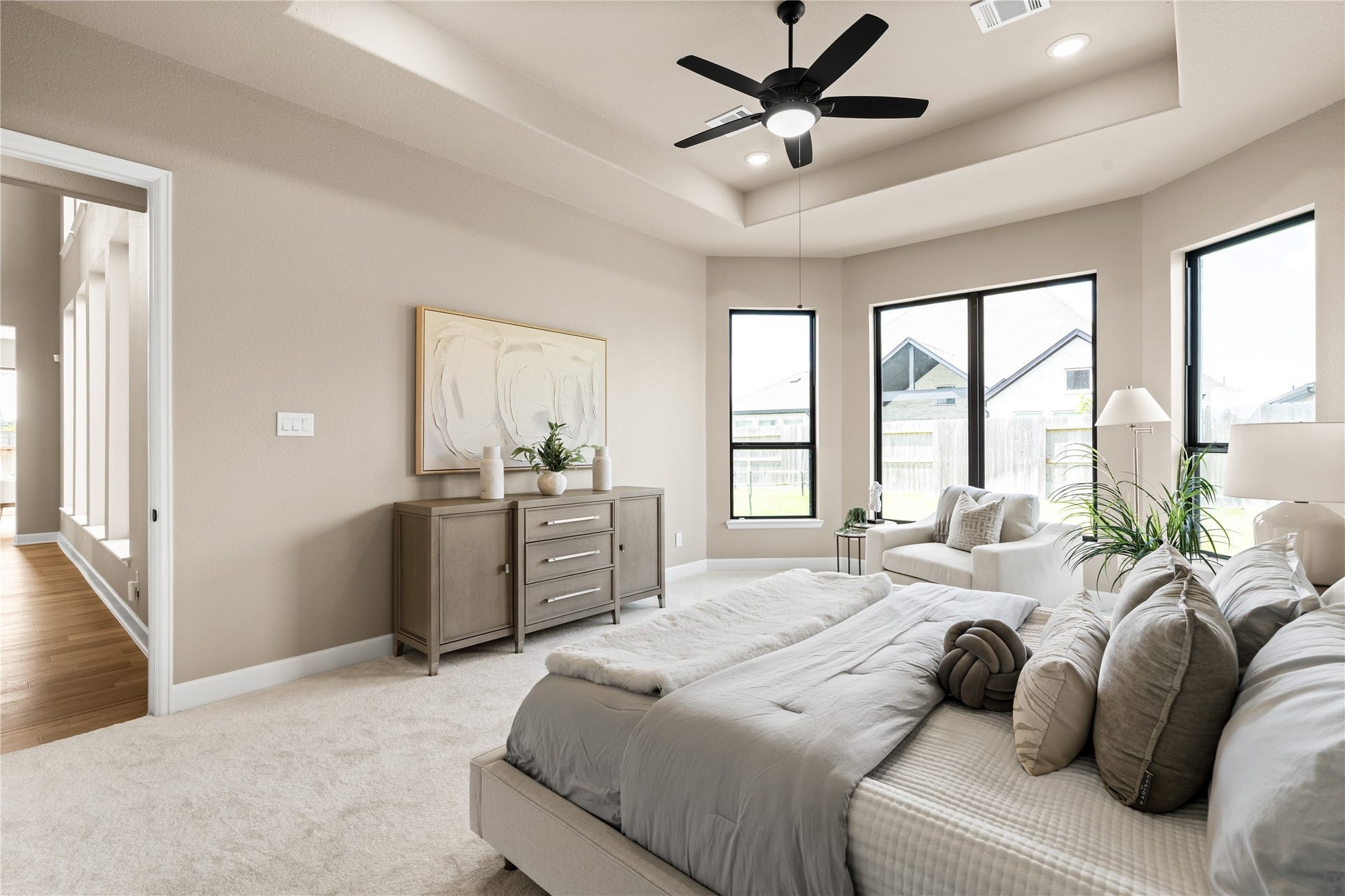 9607 Maple Wood Drive, Missouri City, TX 77459 Primary bedroom with plush carpeting, neutral walls, and a stylish ceiling fan, offering a serene and versatile space. *Virtually Staged*