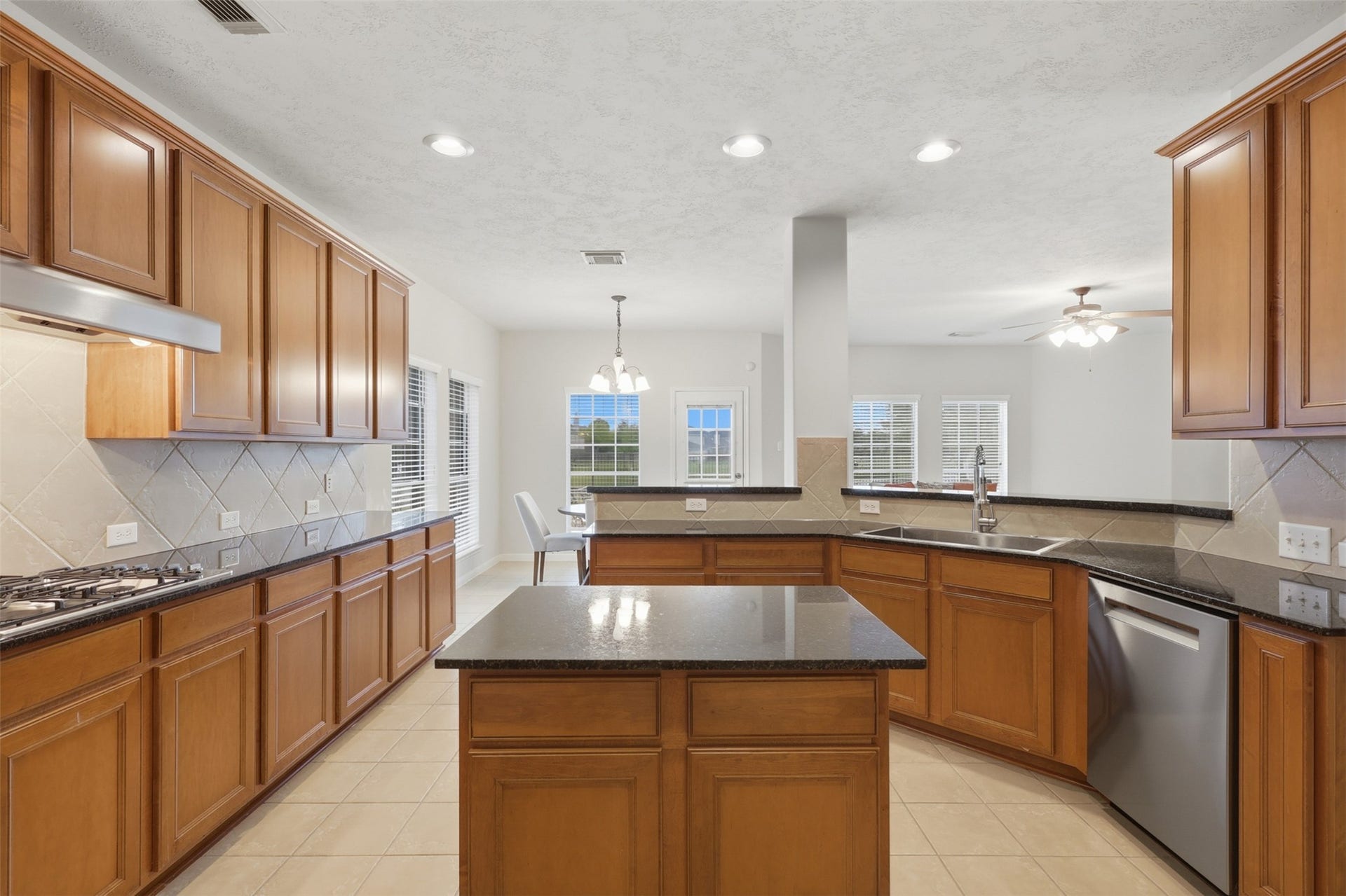 13806 Cove Landing Lane, Rosharon, TX 77583 The generous kitchen features abundant cabinetry, granite countertops, a center island, recessed lighting, and an open layout.