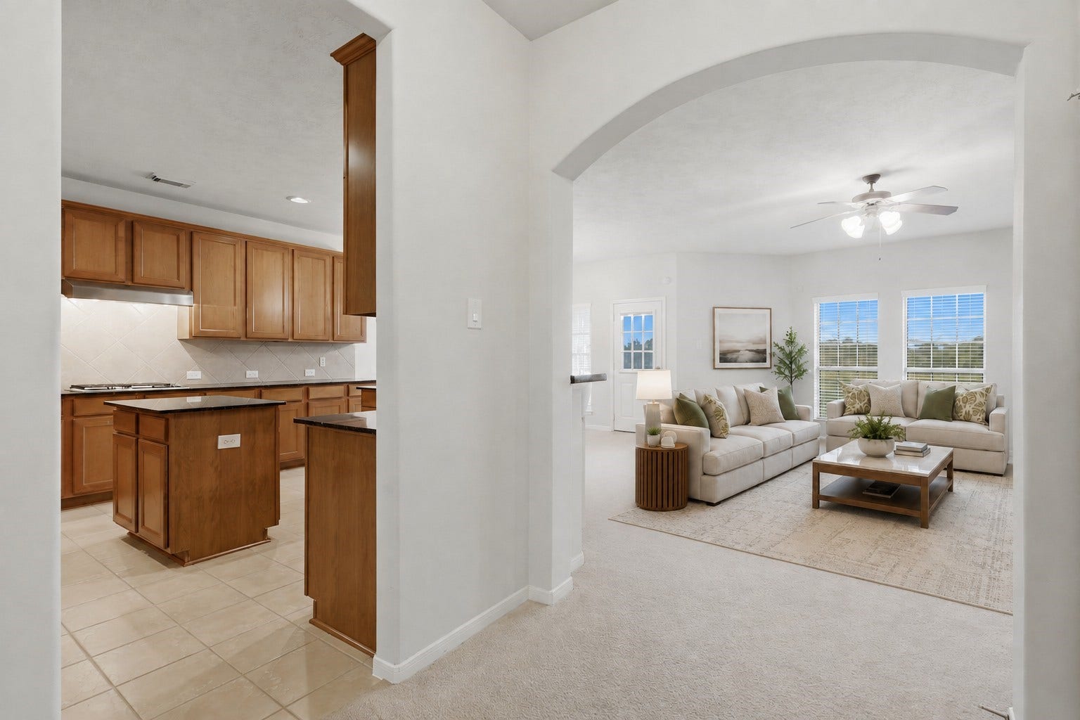13806 Cove Landing Lane, Rosharon, TX 77583 A wide arched opening creates an inviting connection between the kitchen and spacious family room.**Virtually staged