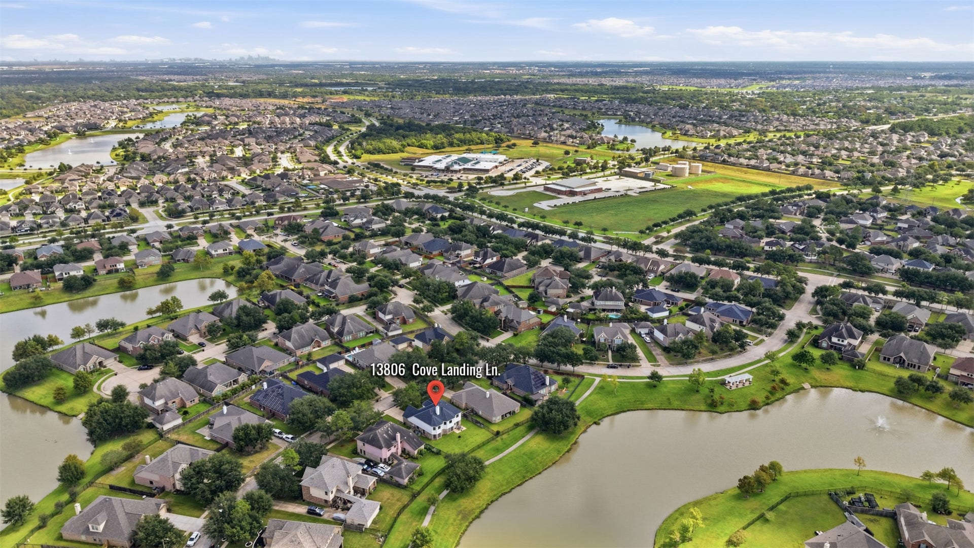 13806 Cove Landing Lane, Rosharon, TX 77583 A broader aerial view highlights the homes convenient setting within a well-planned community surrounded by multiple lakes and green spaces.