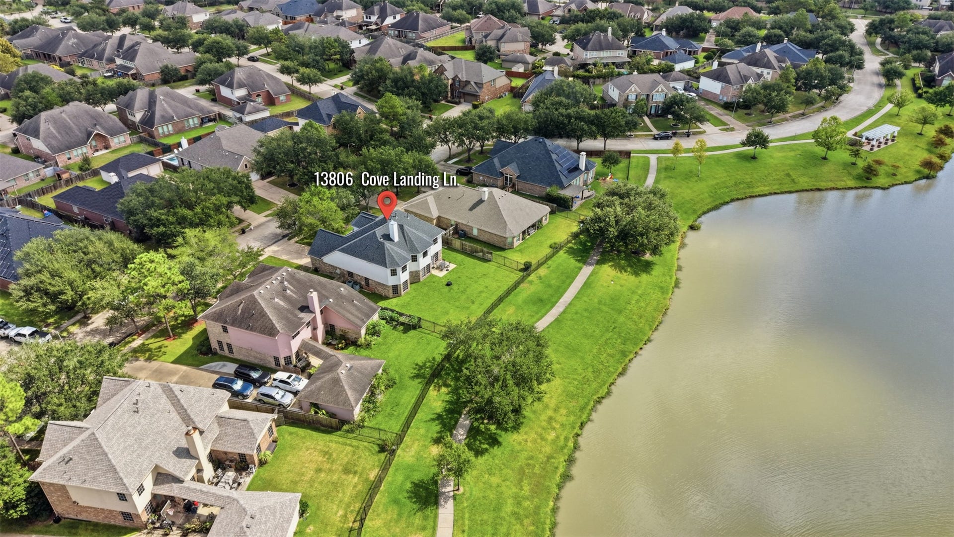 13806 Cove Landing Lane, Rosharon, TX 77583 This aerial view shows the property positioned just steps from the lake and neighborhood walking trail.