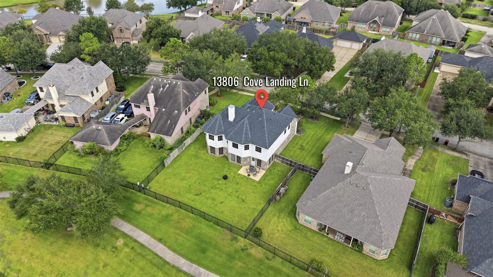 13806 Cove Landing Lane, Rosharon, TX 77583 An aerial view highlights the homes generous lot, fenced backyard, and position near the community lake.
