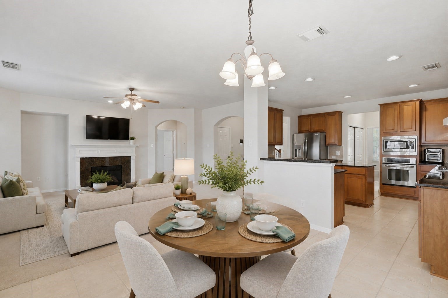 13806 Cove Landing Lane, Rosharon, TX 77583 An open-concept layout seamlessly connects the breakfast area, kitchen, and family room for easy everyday living and entertaining.**Virtually staged