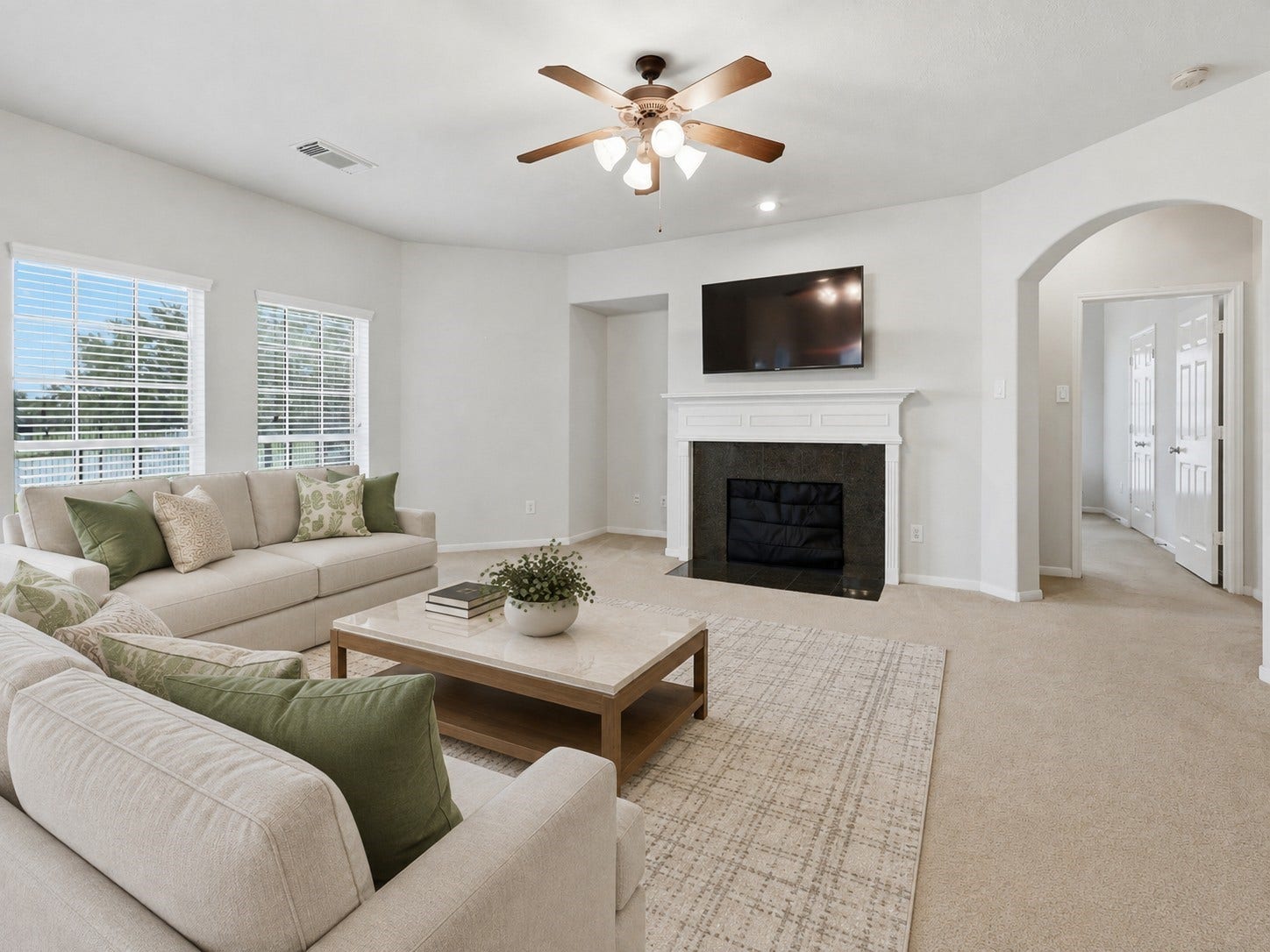 13806 Cove Landing Lane, Rosharon, TX 77583 The family room is anchored by a classic fireplace and enhanced by large windows, generous proportions, and an arched hallway entrance.**Virtually staged