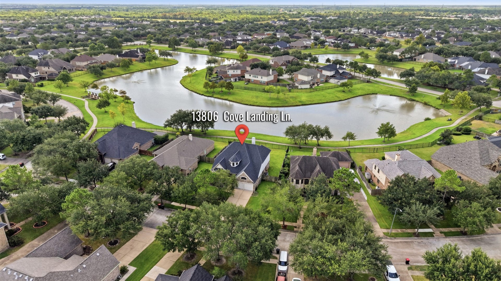 13806 Cove Landing Lane, Rosharon, TX 77583 The home enjoys a desirable setting with a community lake and walking path located directly behind the property.