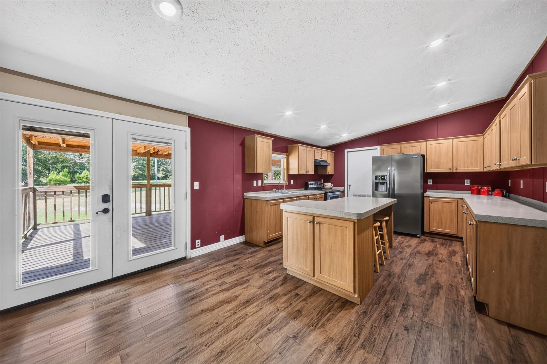 Spacious kitchen with center island, ample cabinetry, and views toward the backyard.