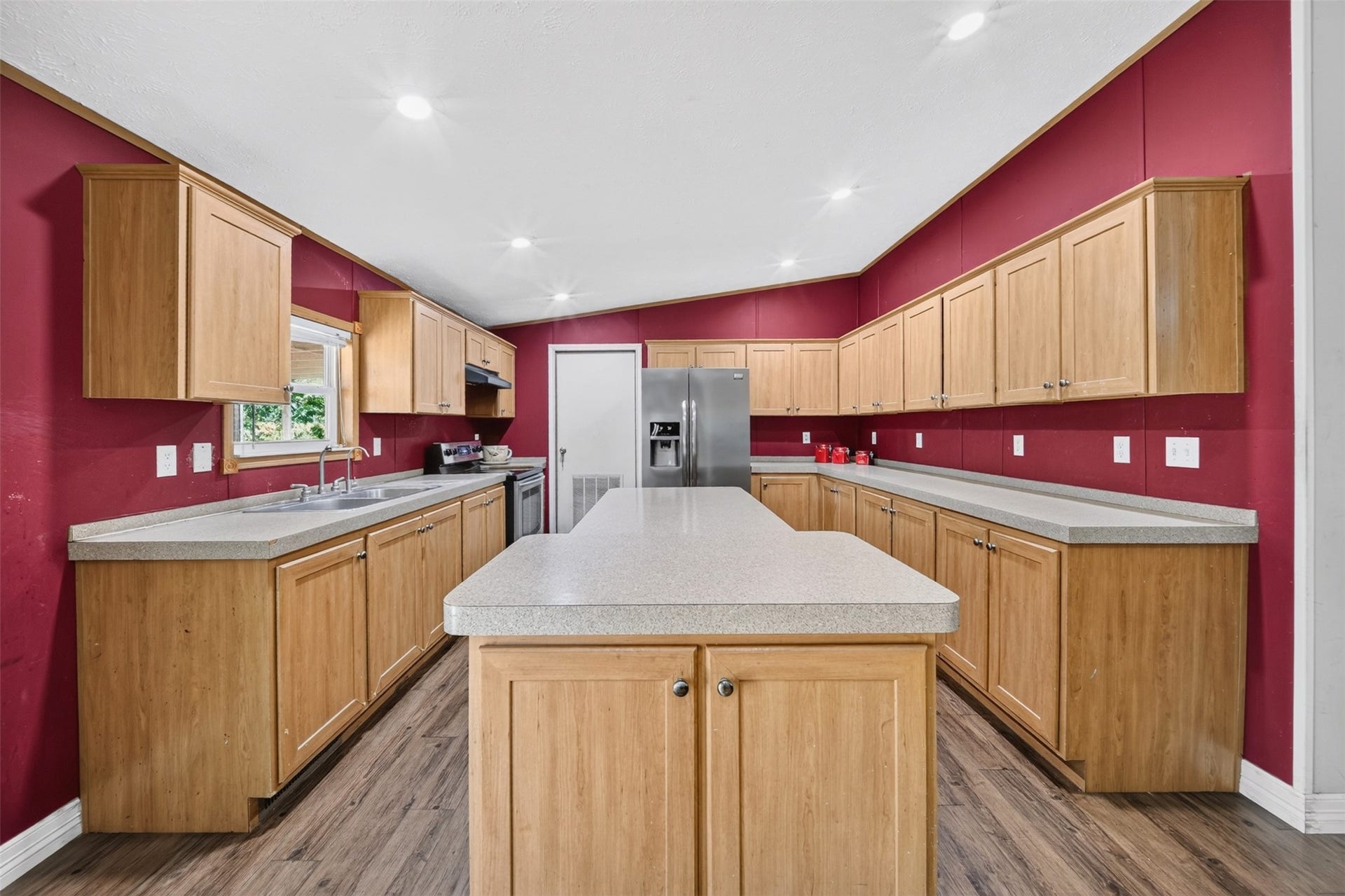 Additional kitchen view highlighting the island and functional layout.