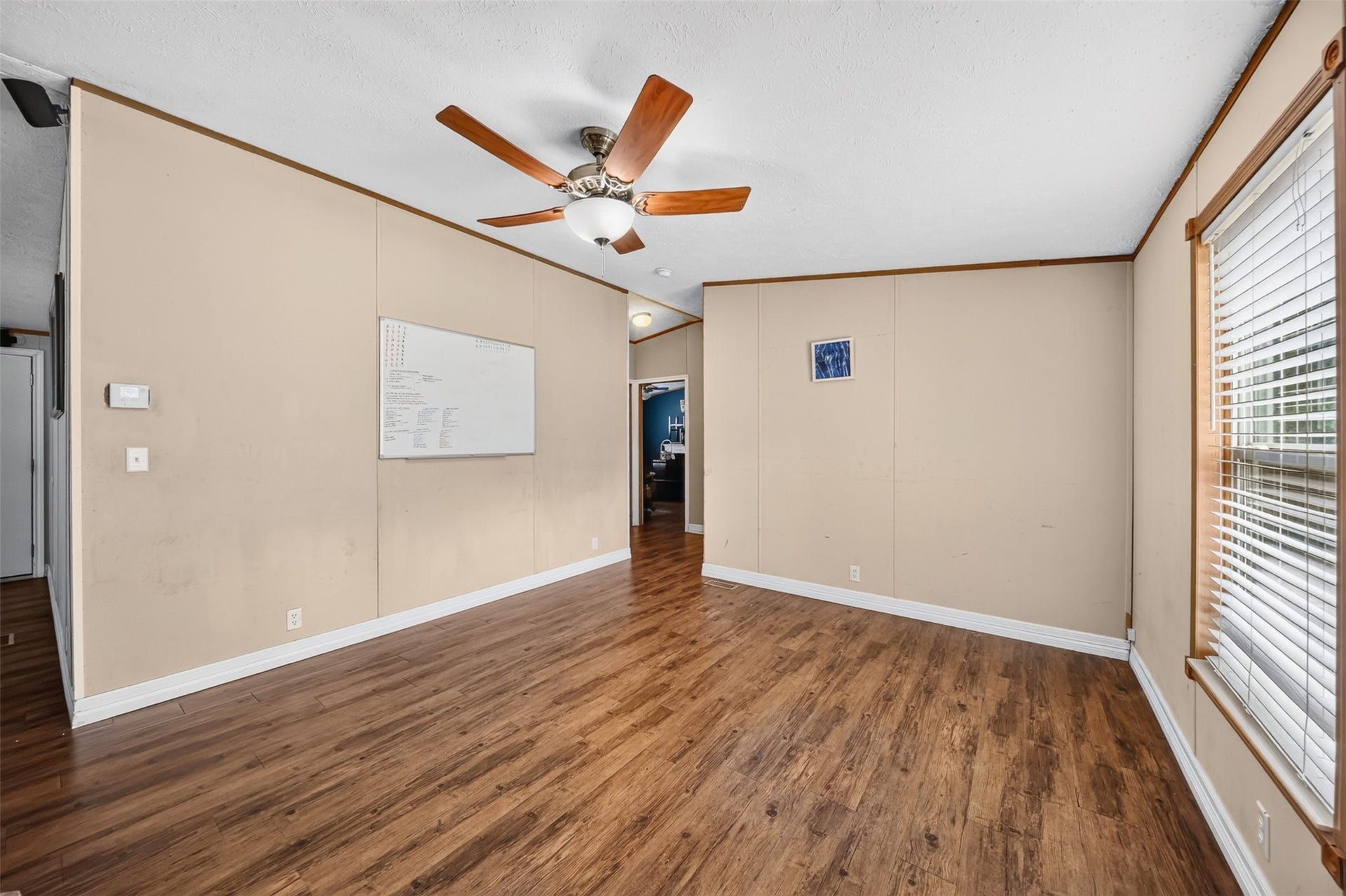 Dining area with wood look flooring, ceiling fan, and plenty of room for everyday meals or entertaining.