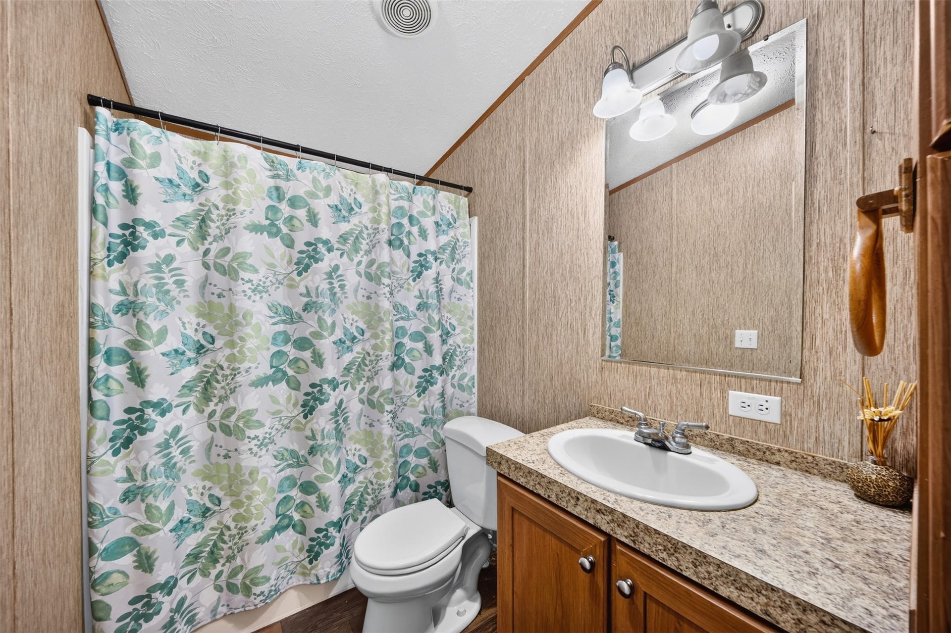 Bathroom with vanity, tub/shower combination, and functional layout.