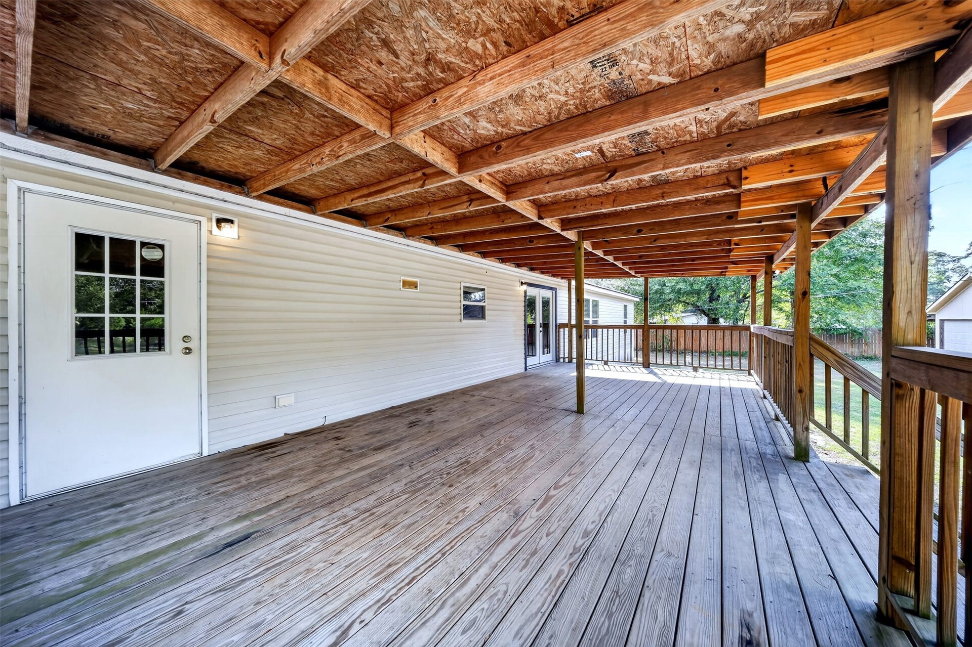 Expansive covered deck offering plenty of room for outdoor seating and entertaining.
